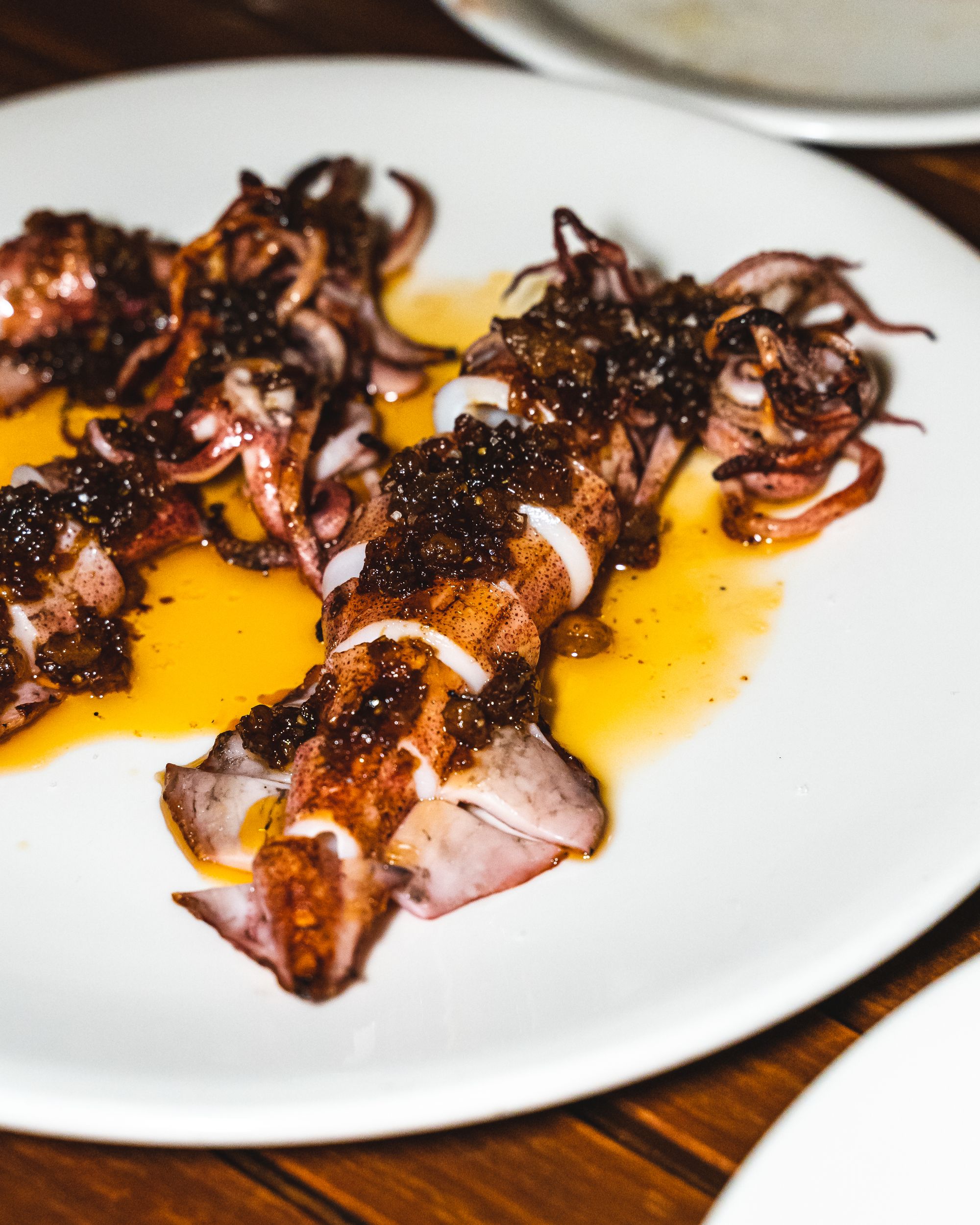 Close up of grilled squid with a yellow sauce