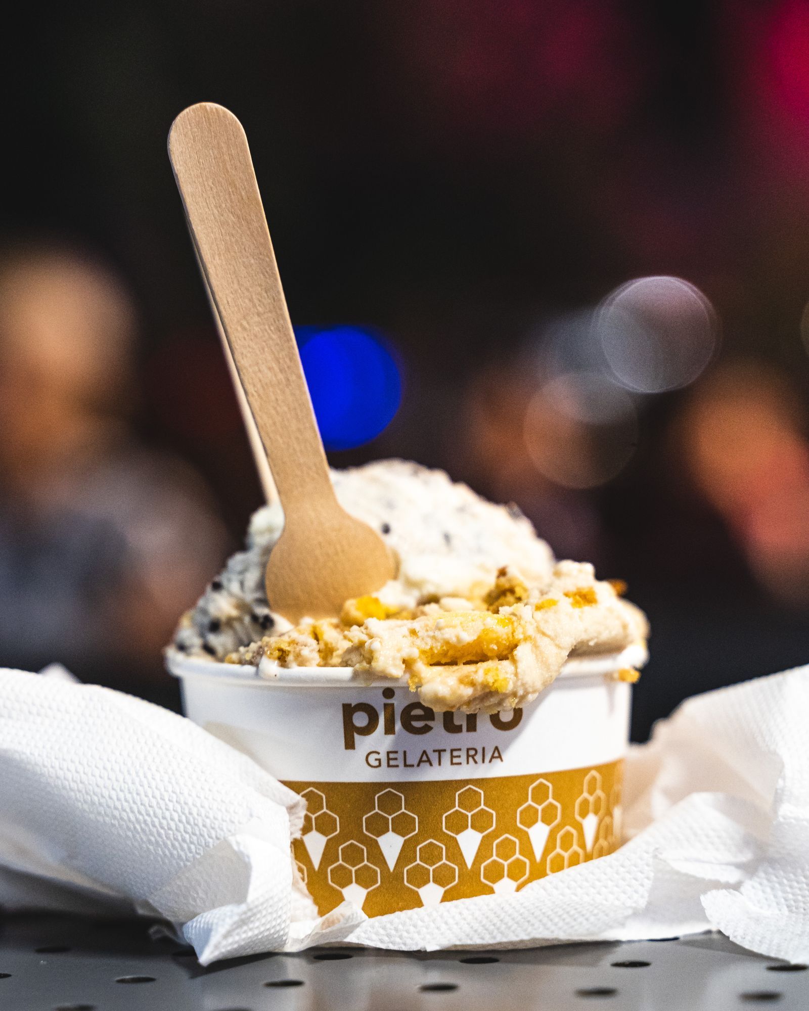 Close up of gelato in a paper cup with Pietro Gelateria text showing