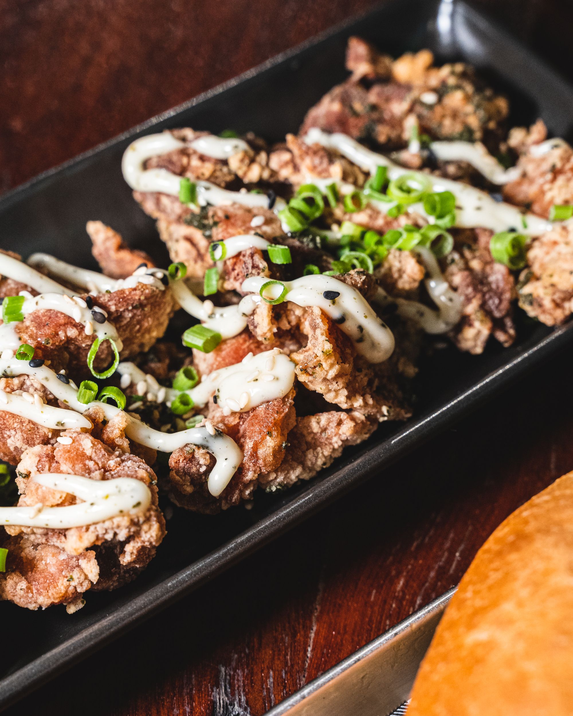 Close up shot of karaage fried chicken with mayo on top