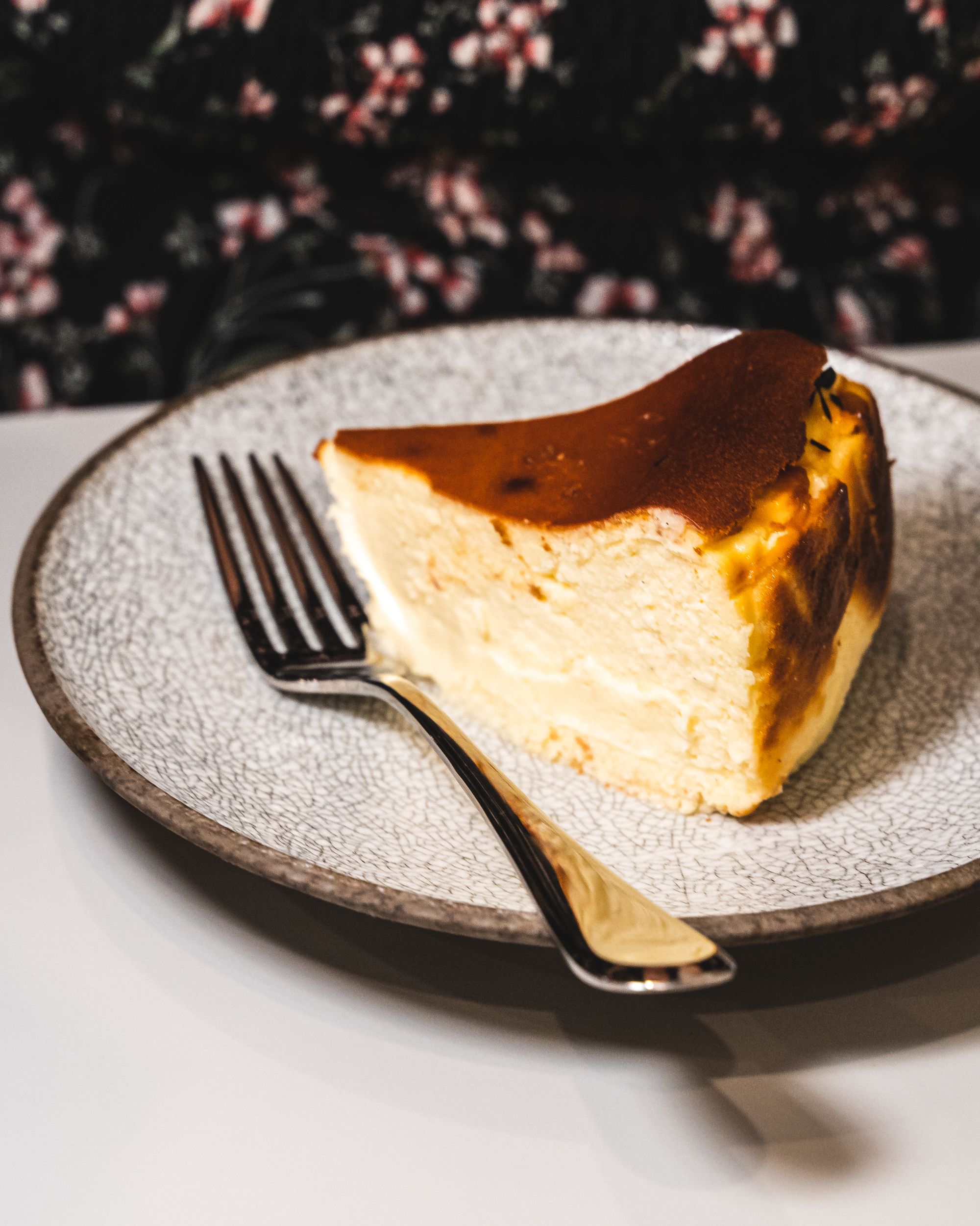 Front view of a slice of cheesecake with a fork