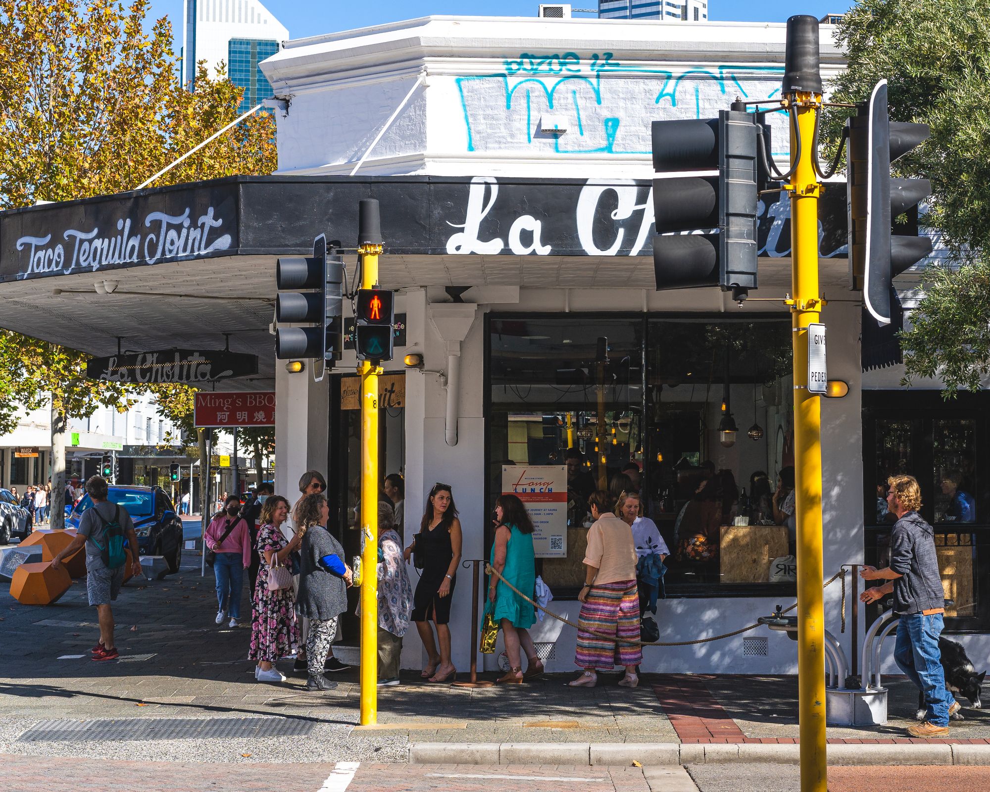 Daytime photo of people lining up to go into La Cholita