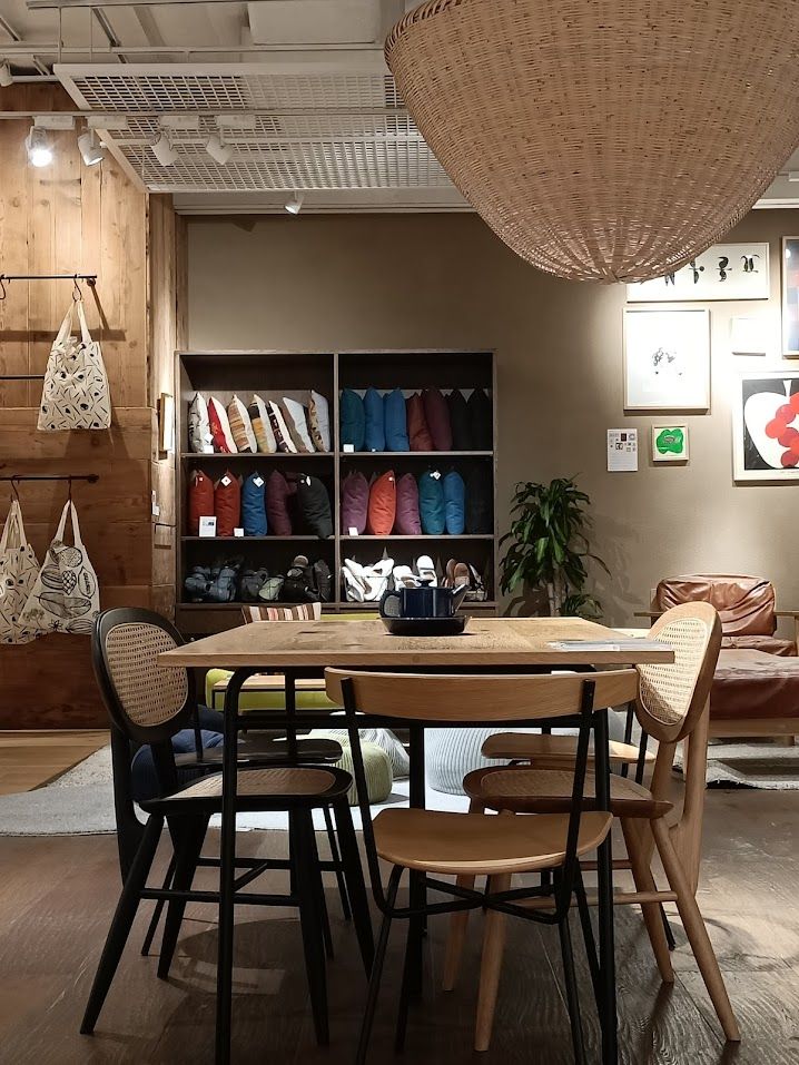 Eye level shot showing a dining table with chairs surrounding it, in a furniture showroom