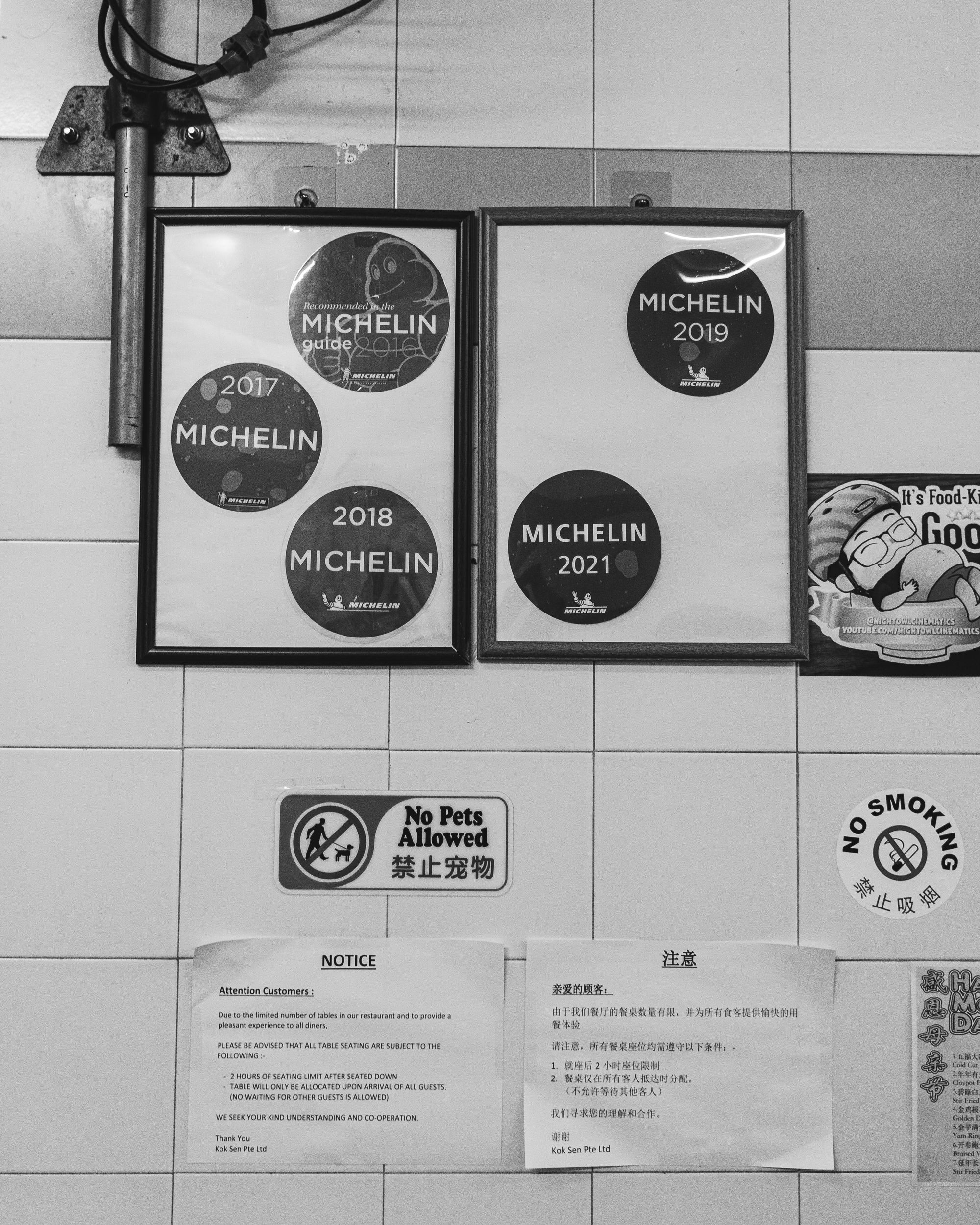 Close up to Michelin guide stickers that has been awarded to Kok Sen