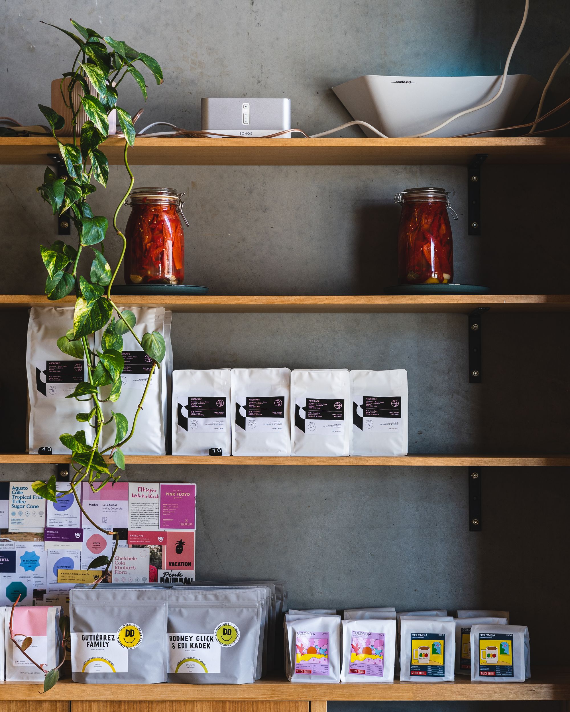 Front on shot of shelving with bags of coffee beans