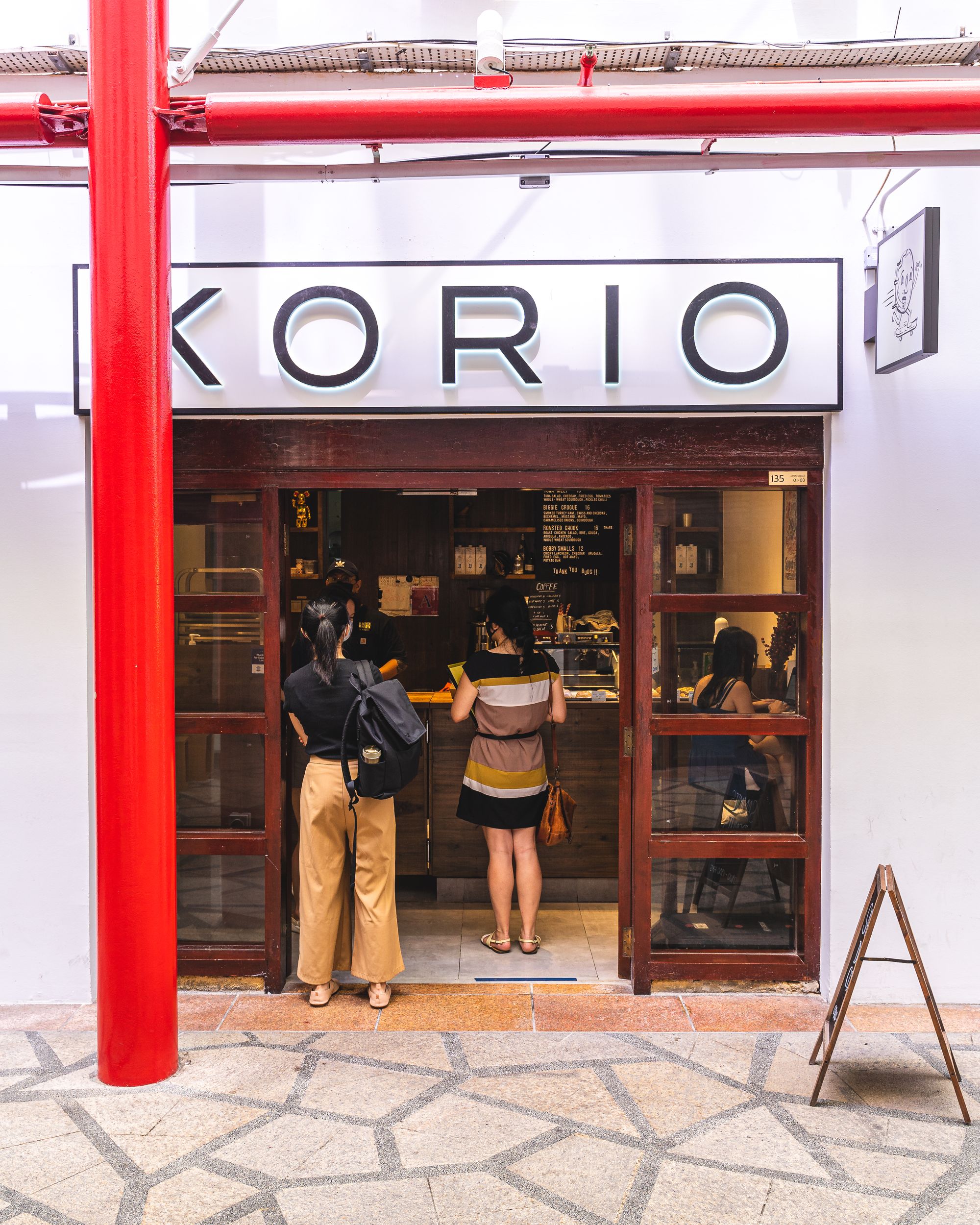 The storefront of Korio showing people lining up