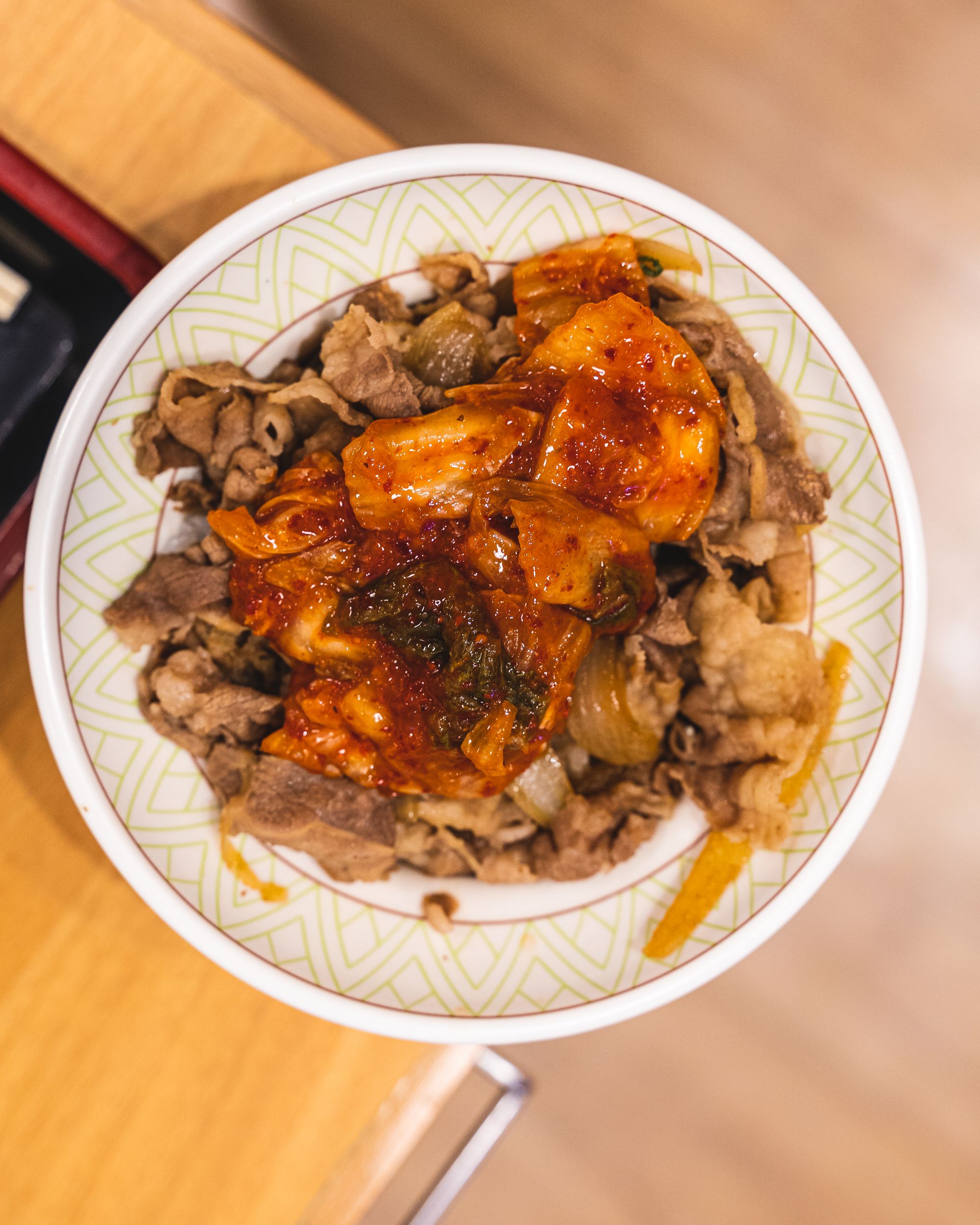 Overhead view of gyudon with pork and kimchi