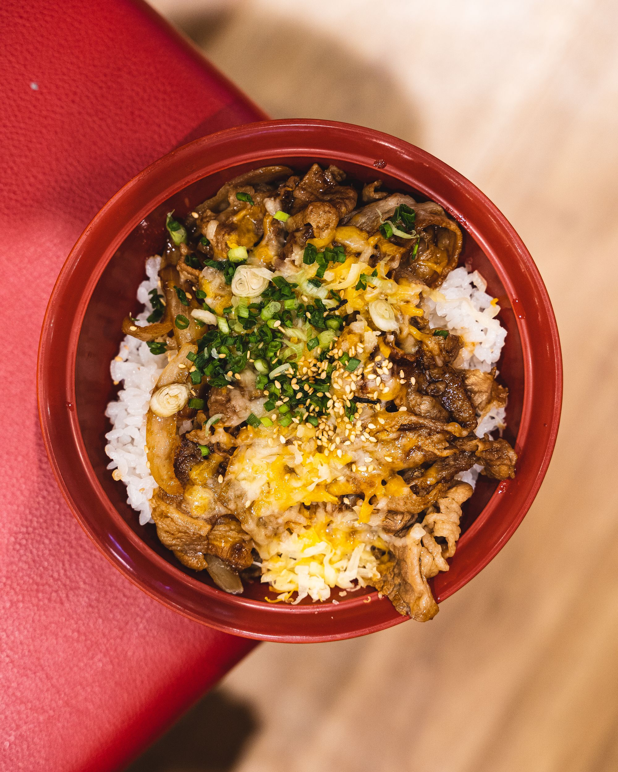 Overhead view of gyudon with a layer of cheese on the top