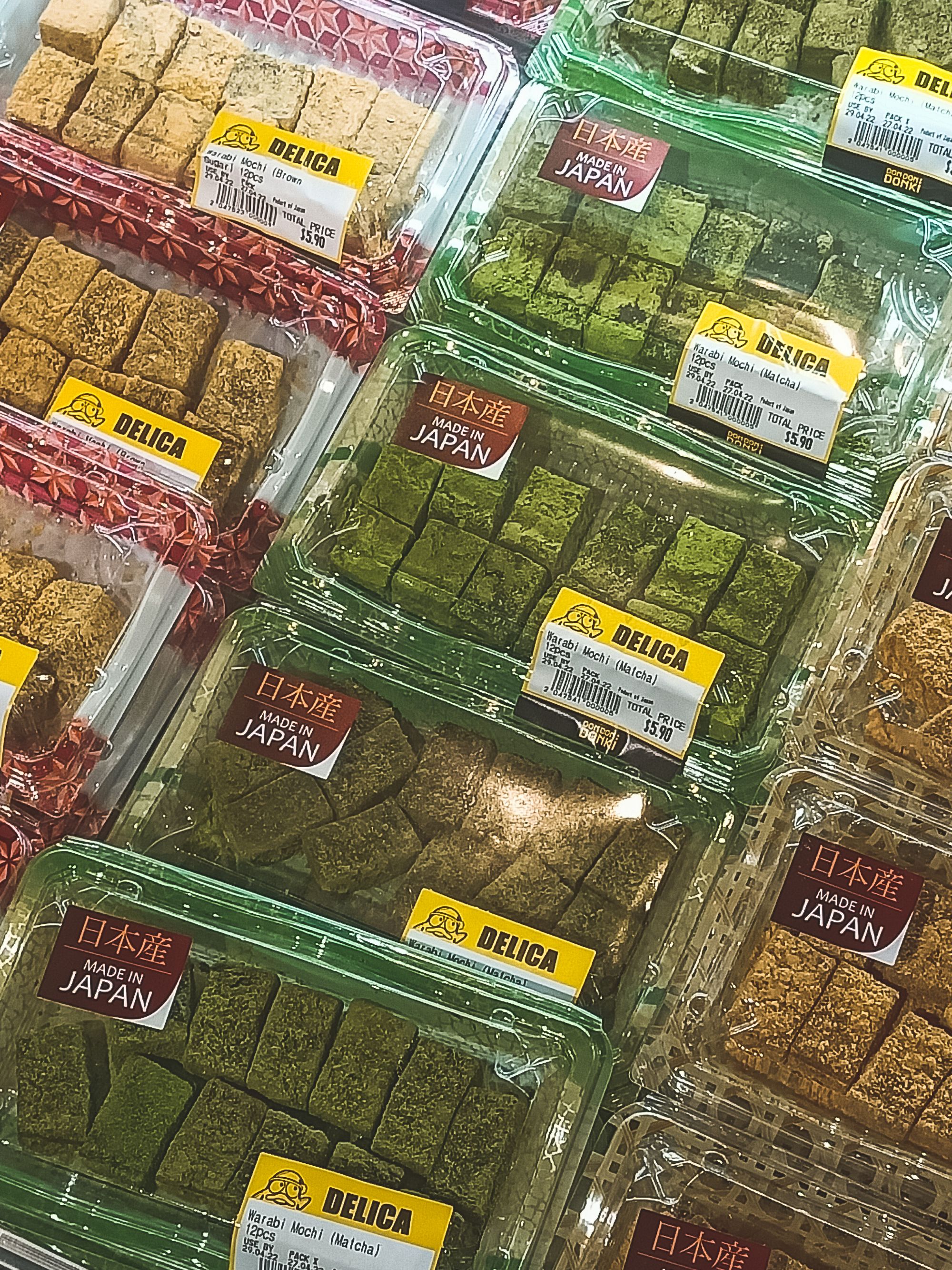 Close up shot of warabi mochi in plastic containers