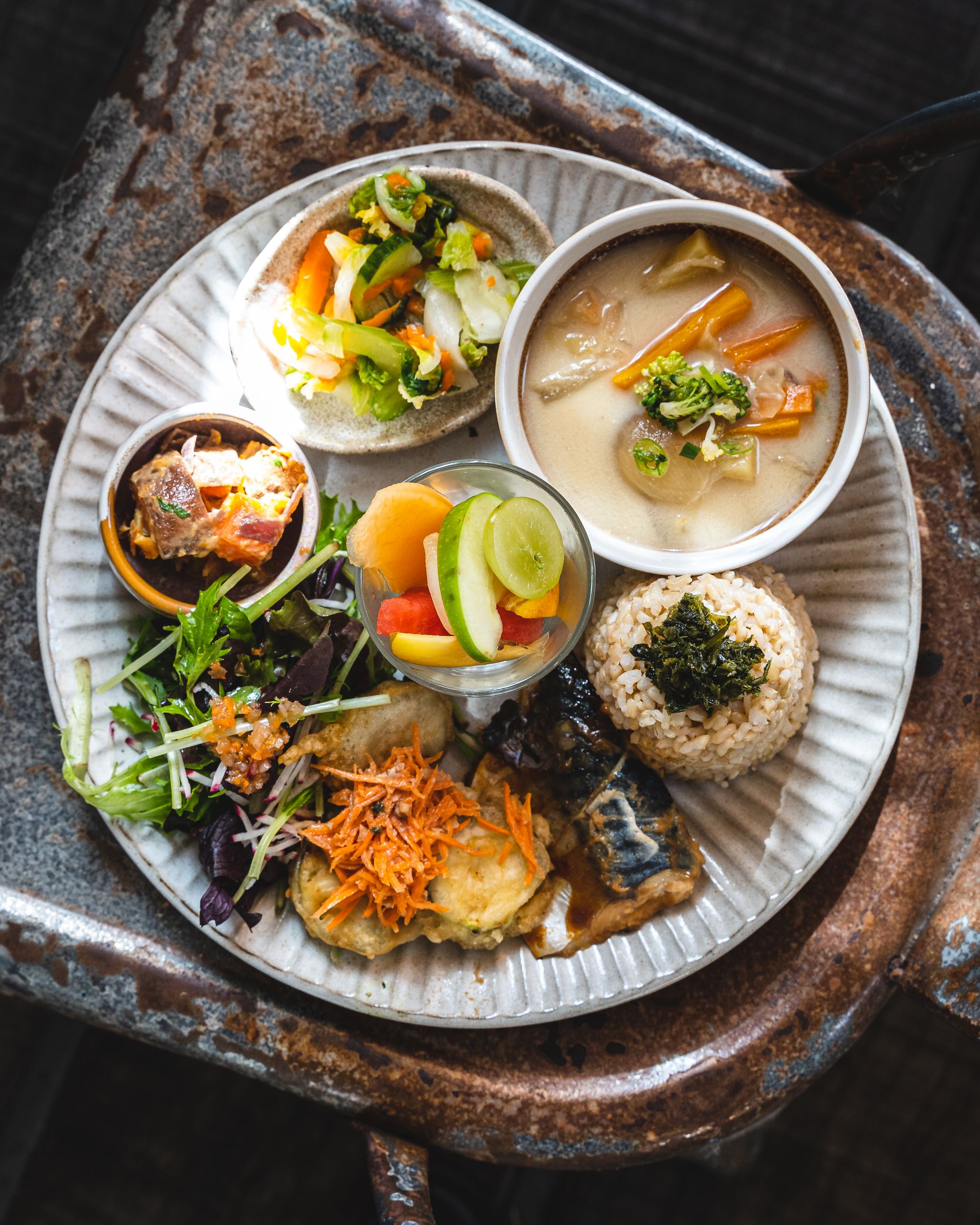 Overhead shot of a plate with many different smaller dishes in smaller bowls