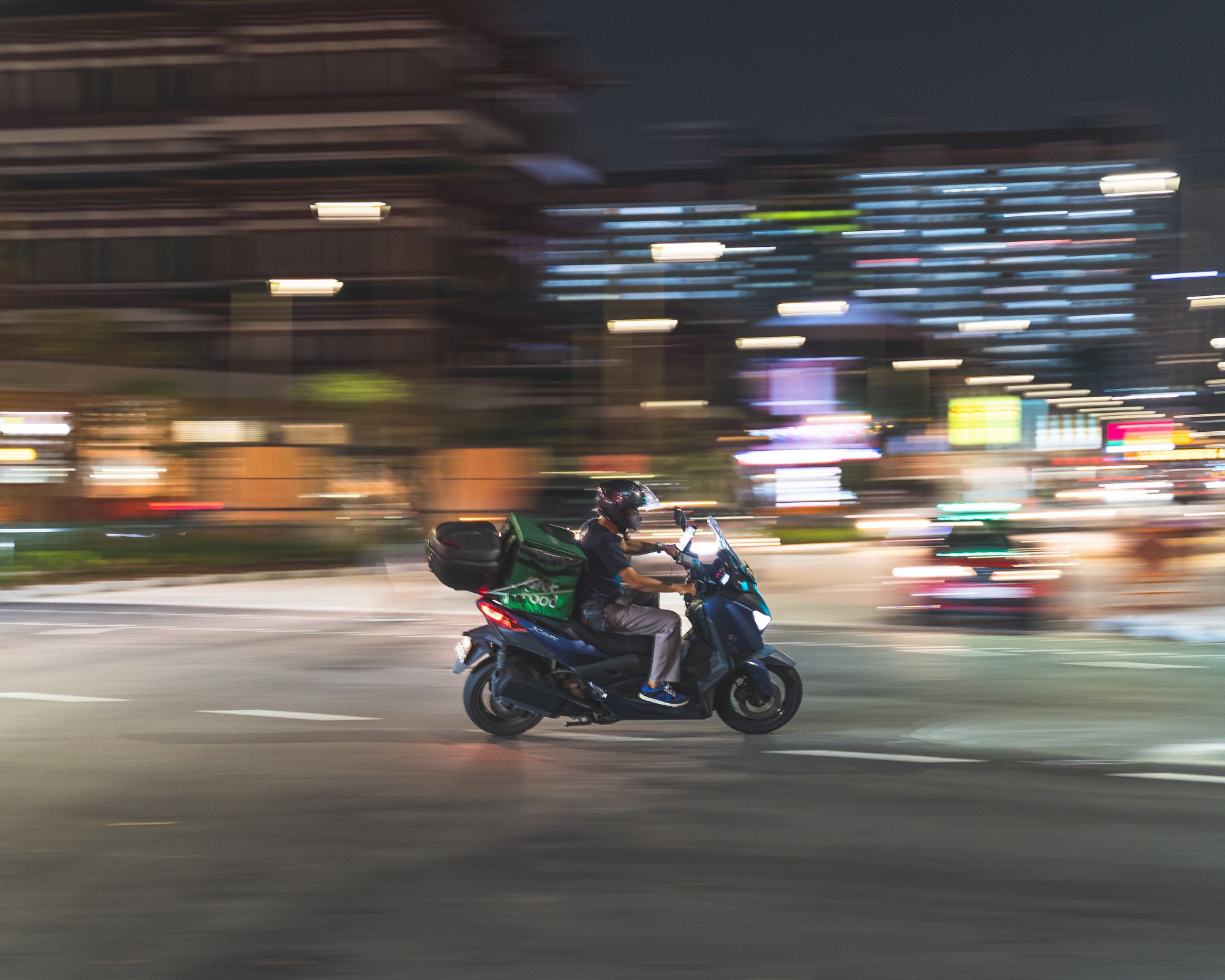 Panning shot of a man on a motorbike