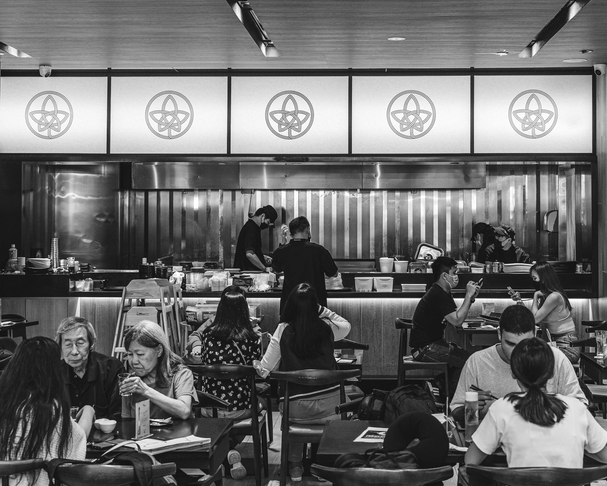 Black and white shot of Tsuta's busy interior with lots of people dining