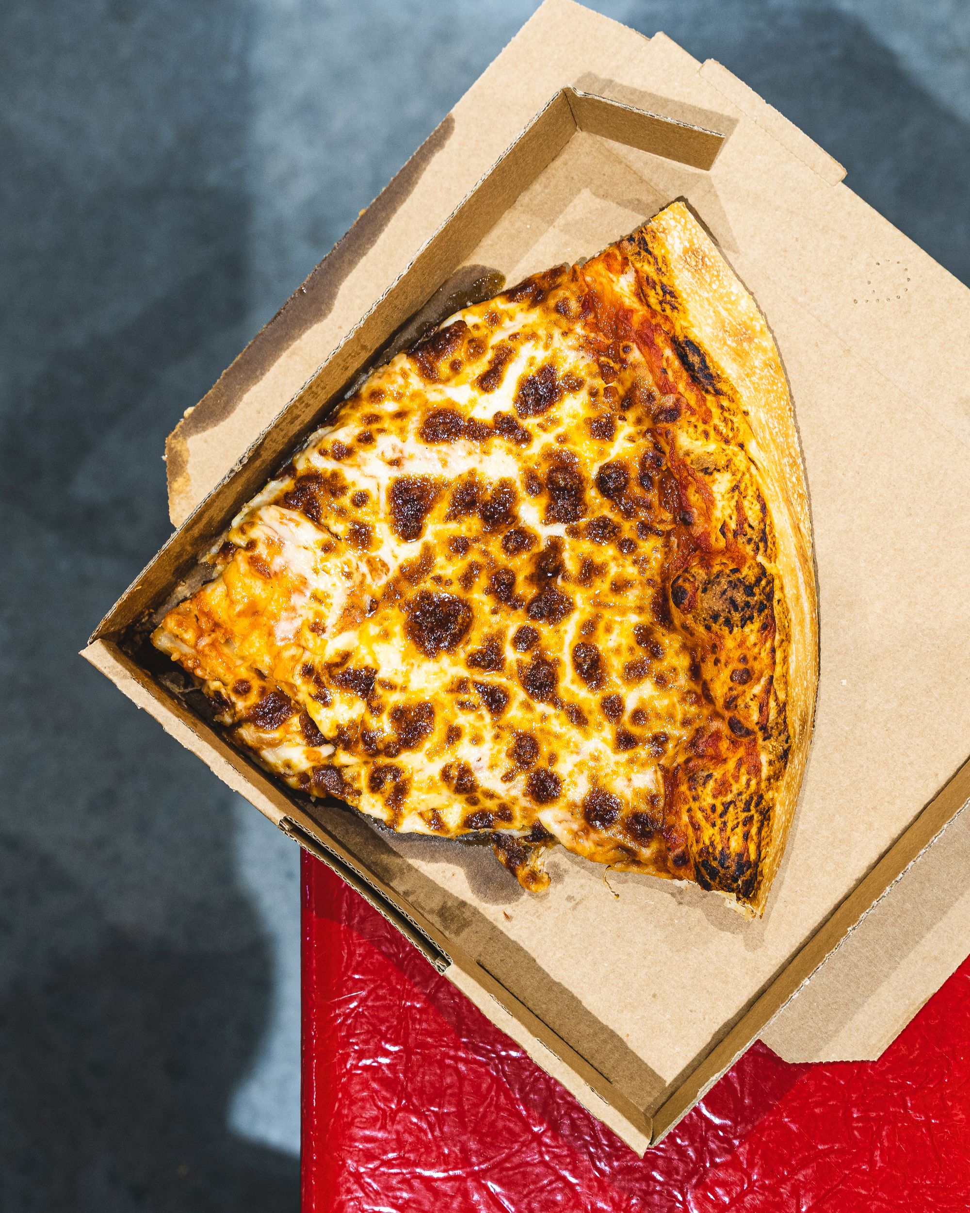 Overhead shot of a big slice of cheese pizza