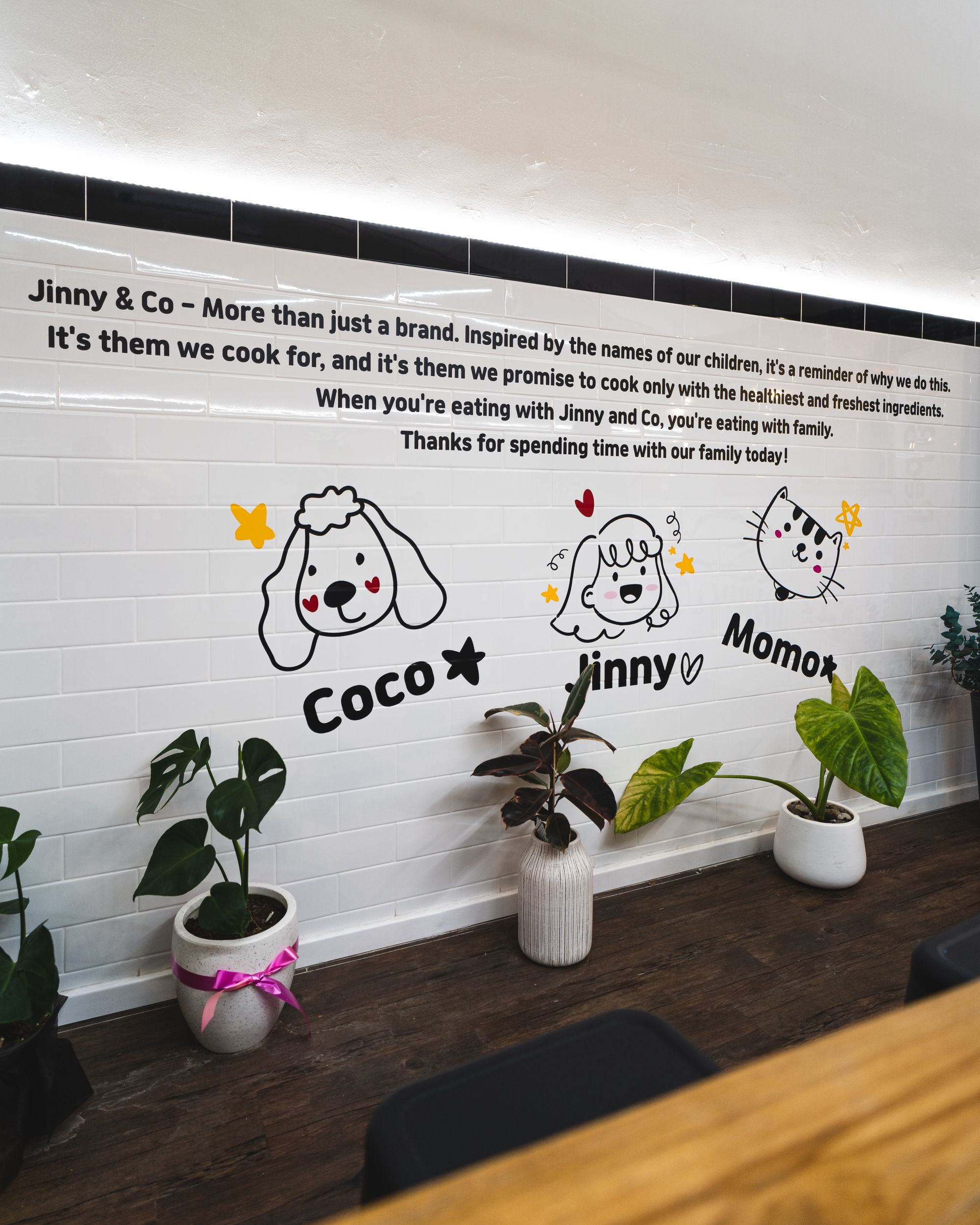 Interior of Jinny&Co showing cartoon stickers of a dog, girl and cat