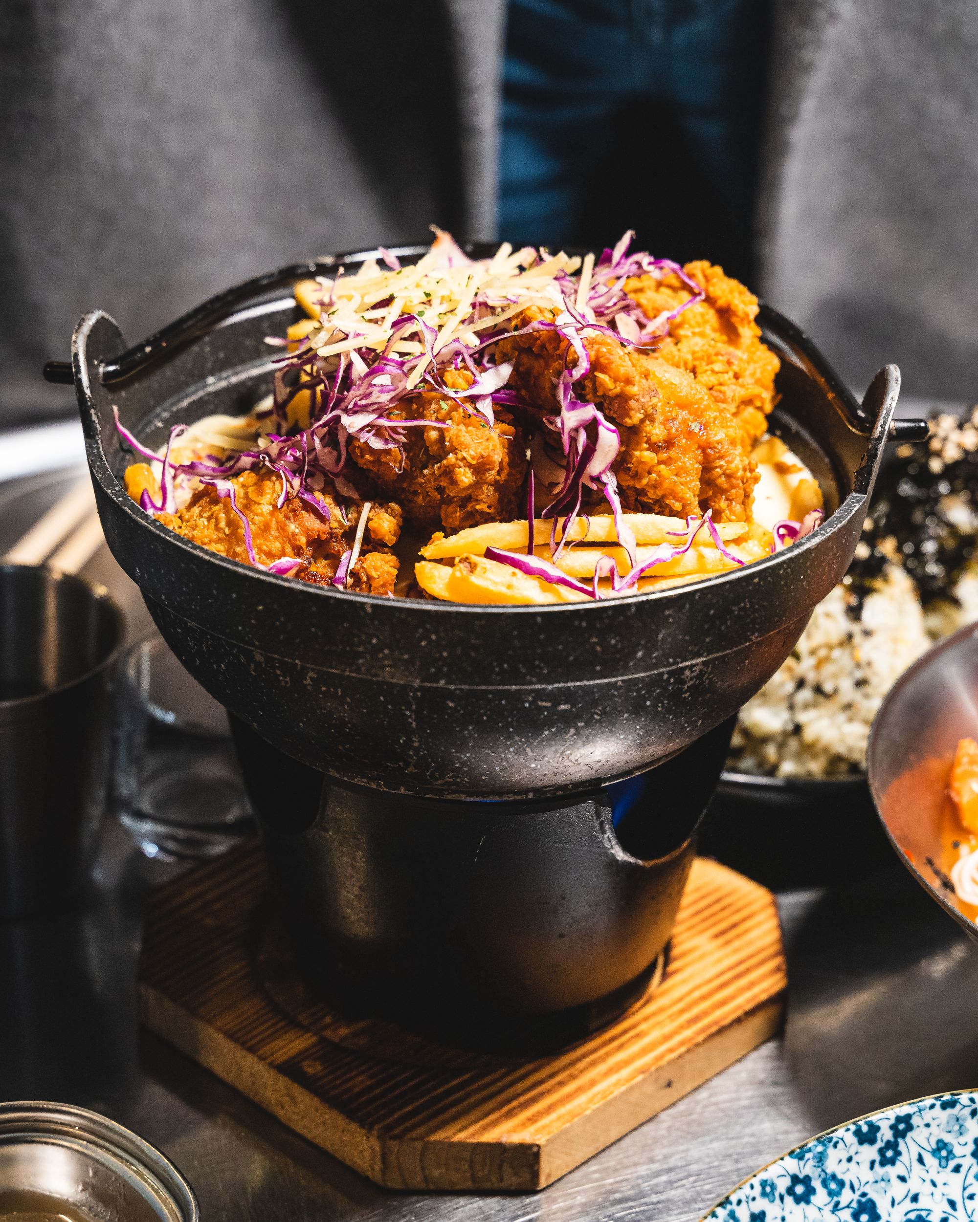 Close up of Korean fried chicken garnished with purple cabbage