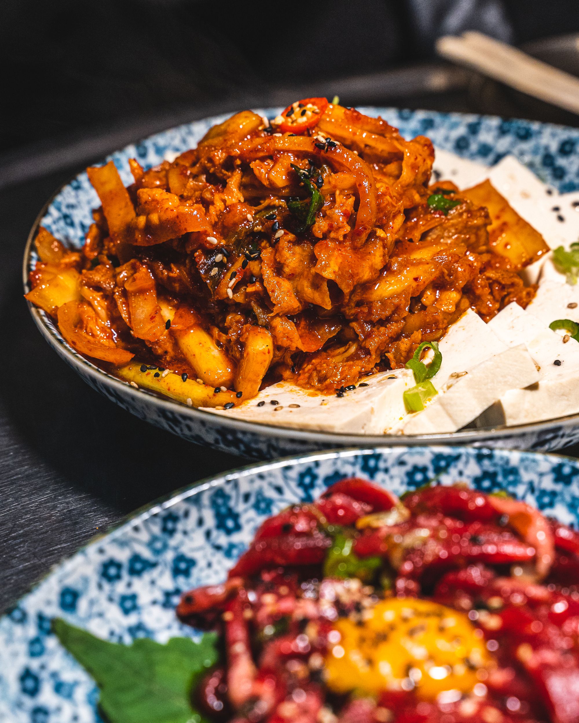 Close up of kimchi, pork and tofu