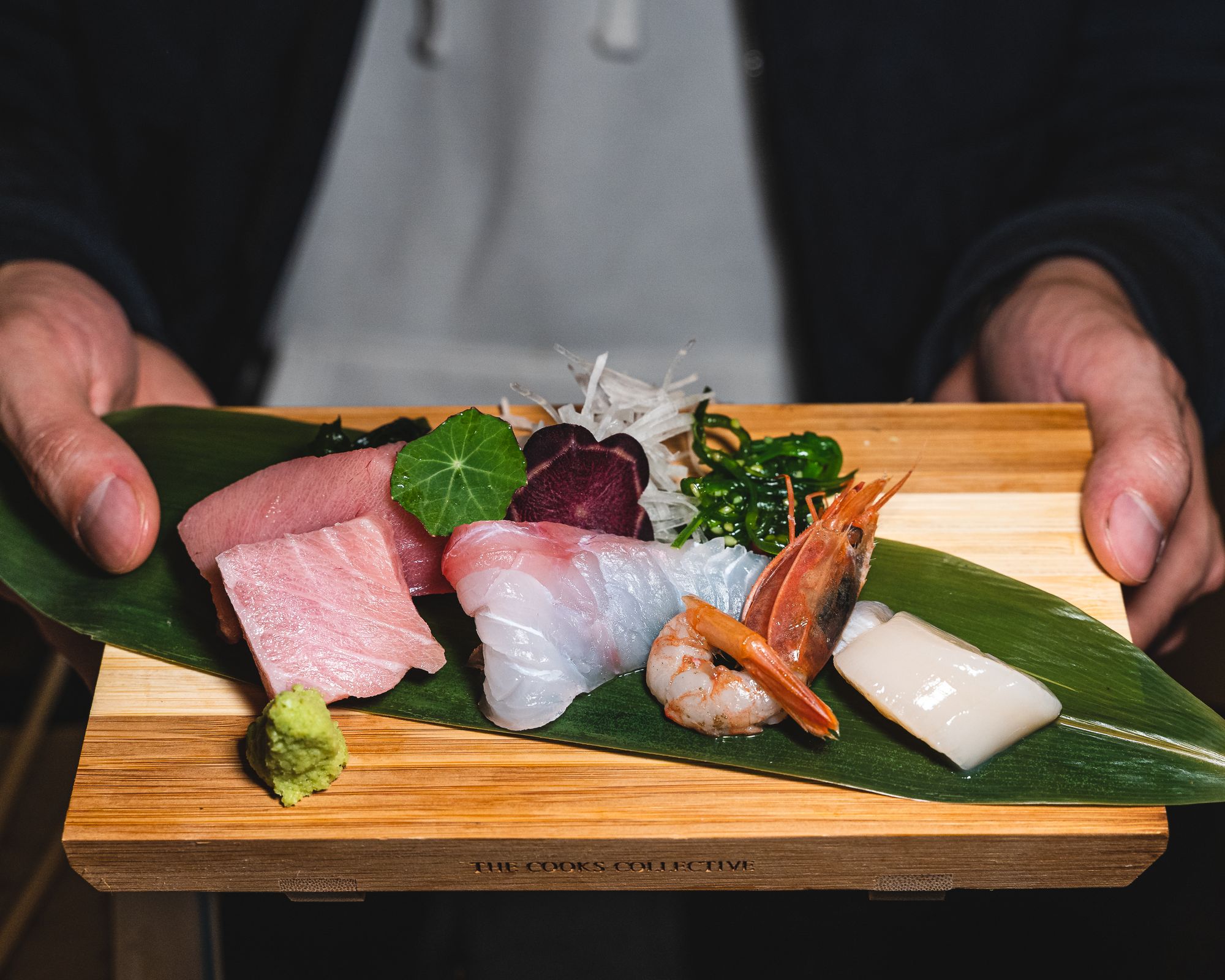 A variety of  sashimi on a wooden board (toro, whitefish, ebi and hotate)