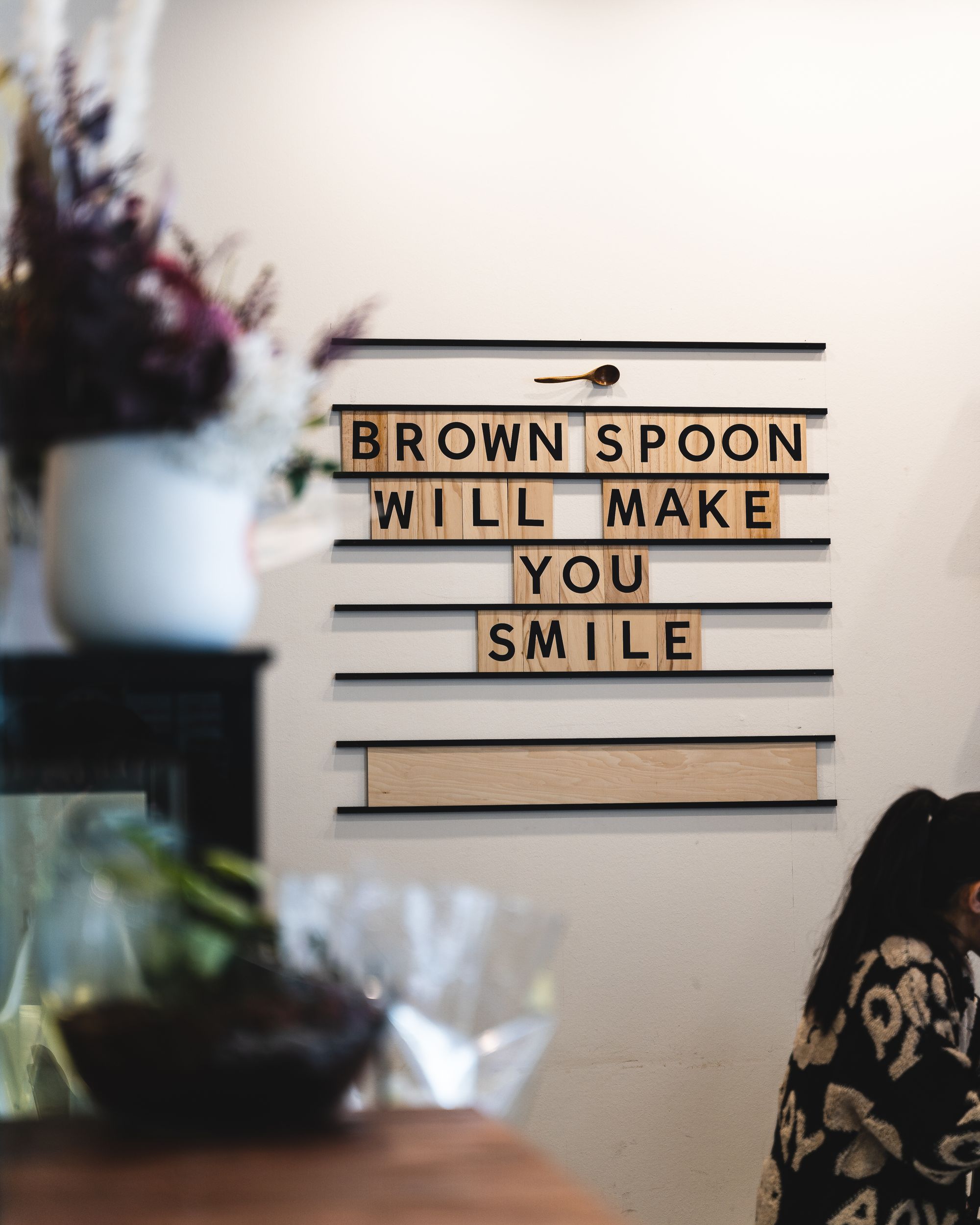 Sign at Brown Spoon saying "brown spoon will make you smile"