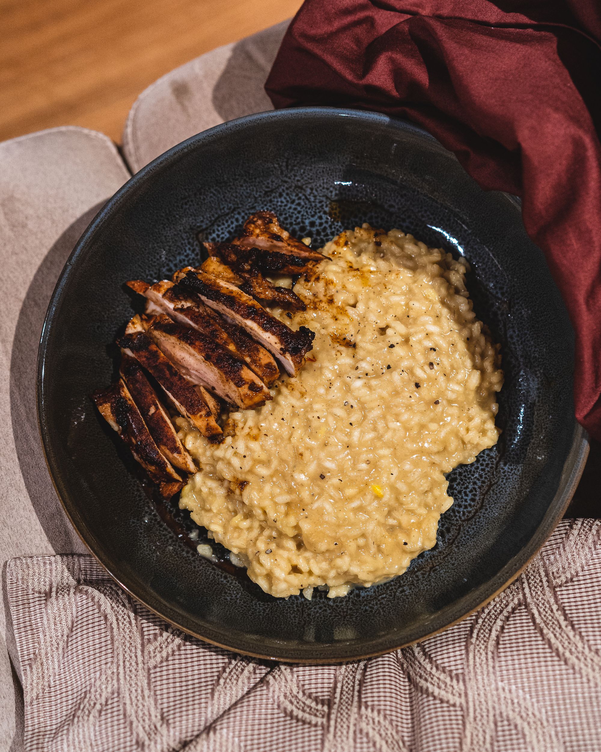 Overhead shot of saffron risotto with a side of chicken thigh