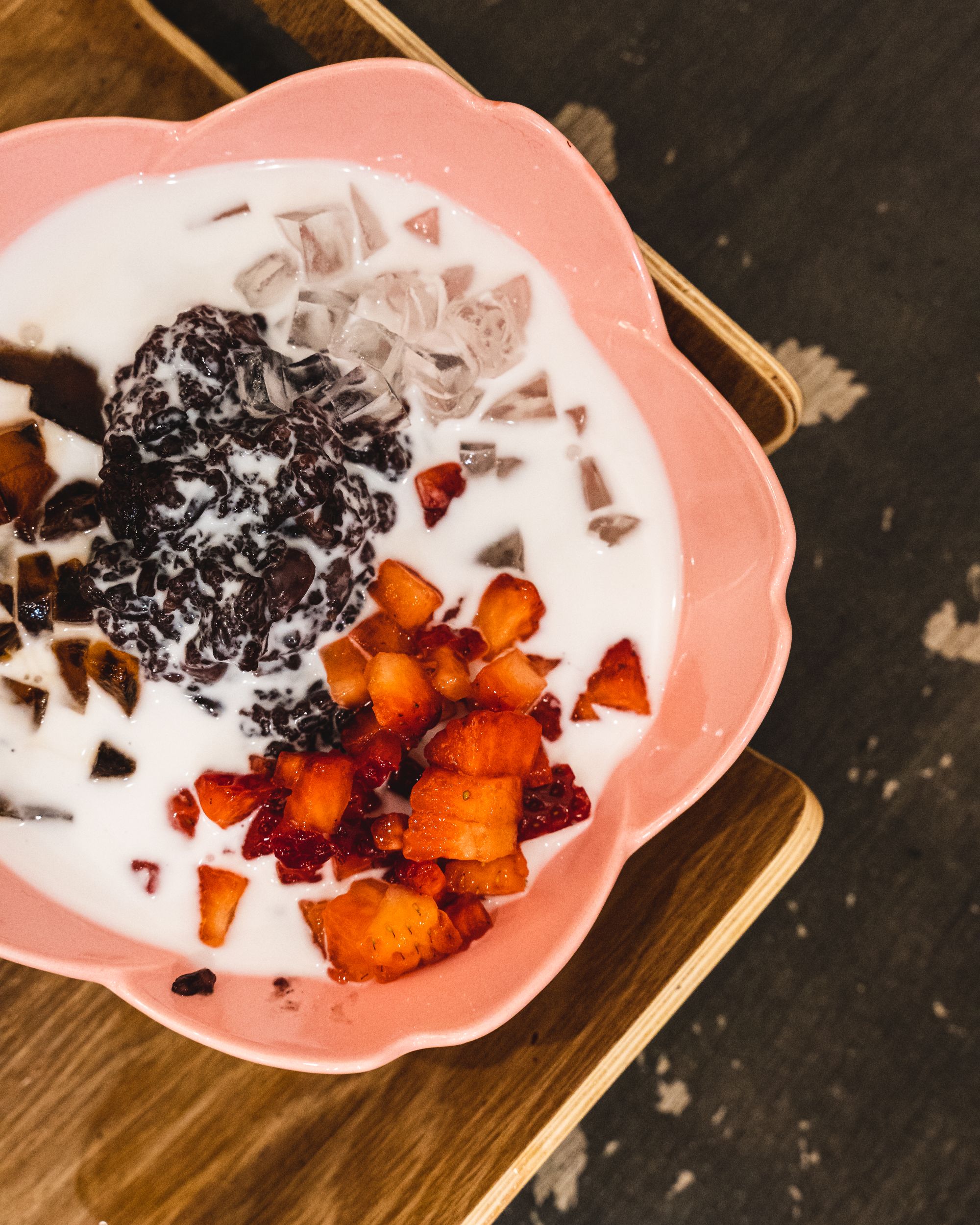 Bowl with coconut milk, diced strawberry and diced jelly