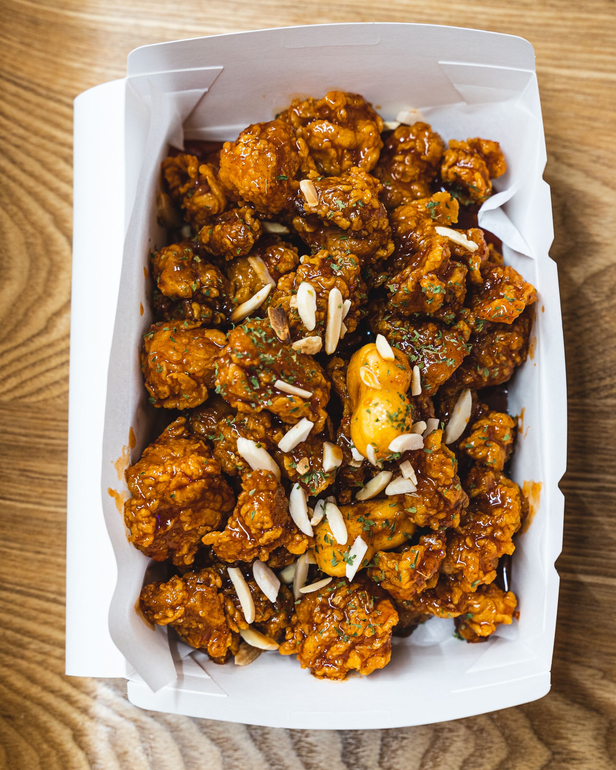 Overhead shot of Korean fried chicken in a paper box