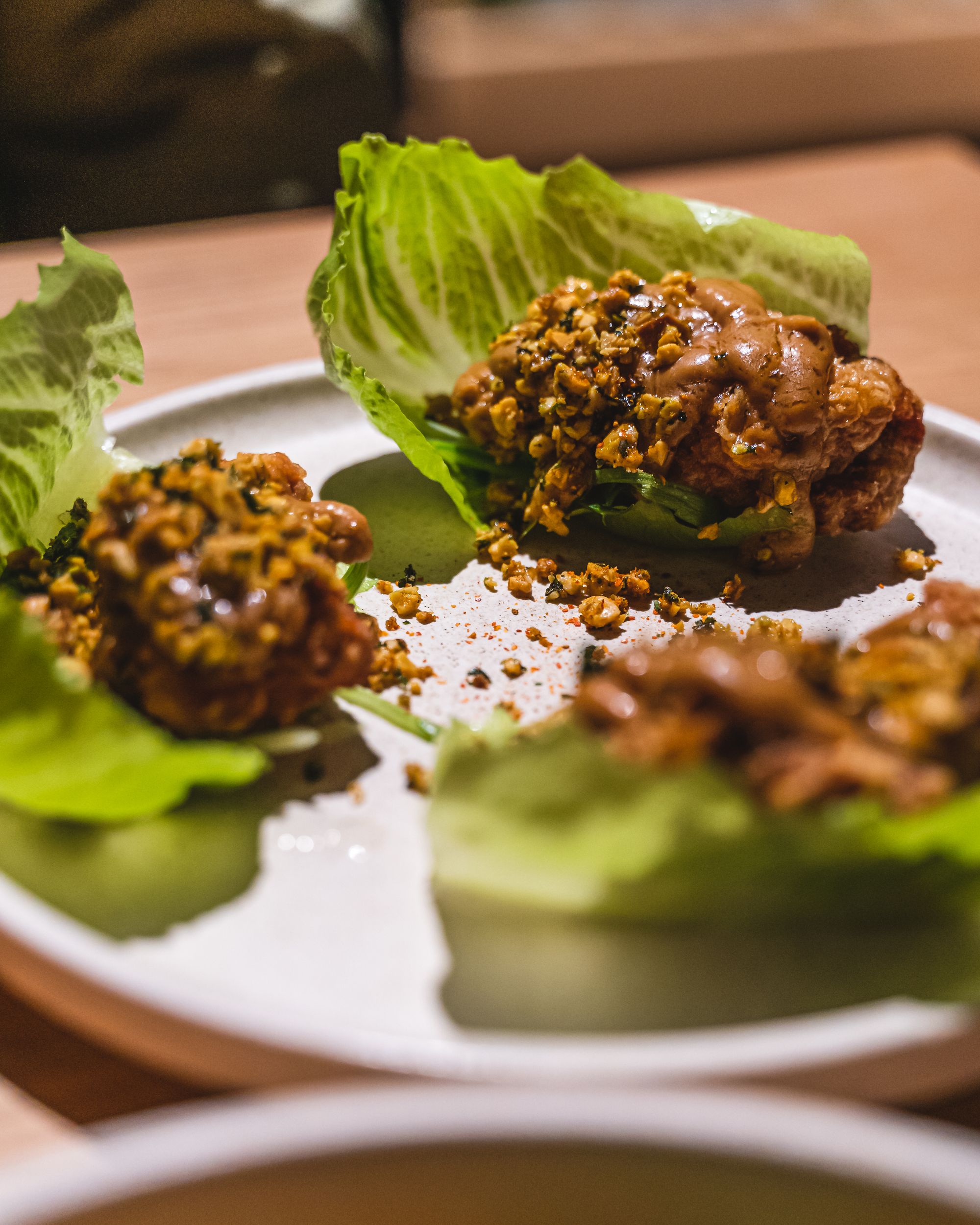 Fried chicken served in a lettuce cup with peanut sauce