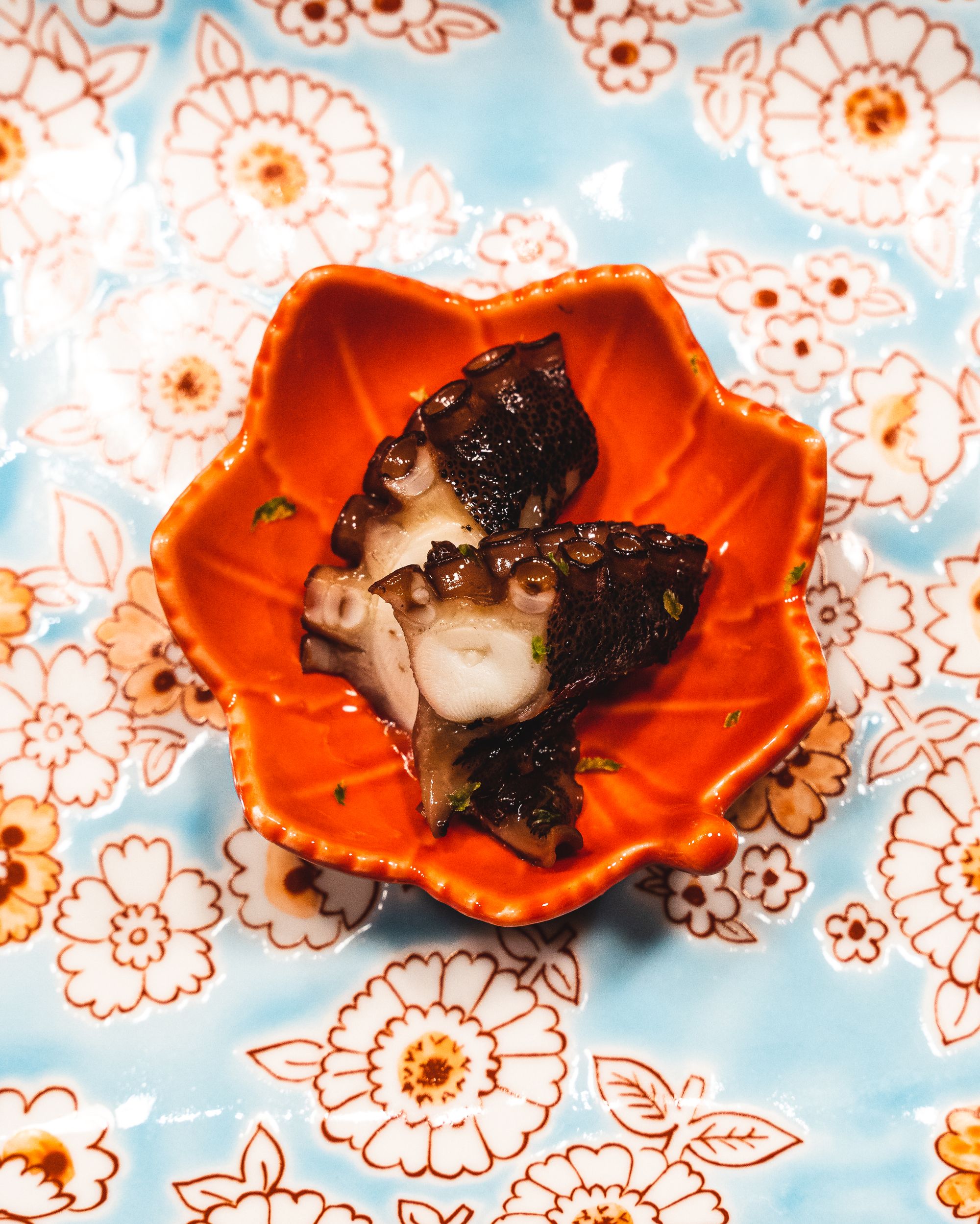 Octopus on a red leaf shaped plate