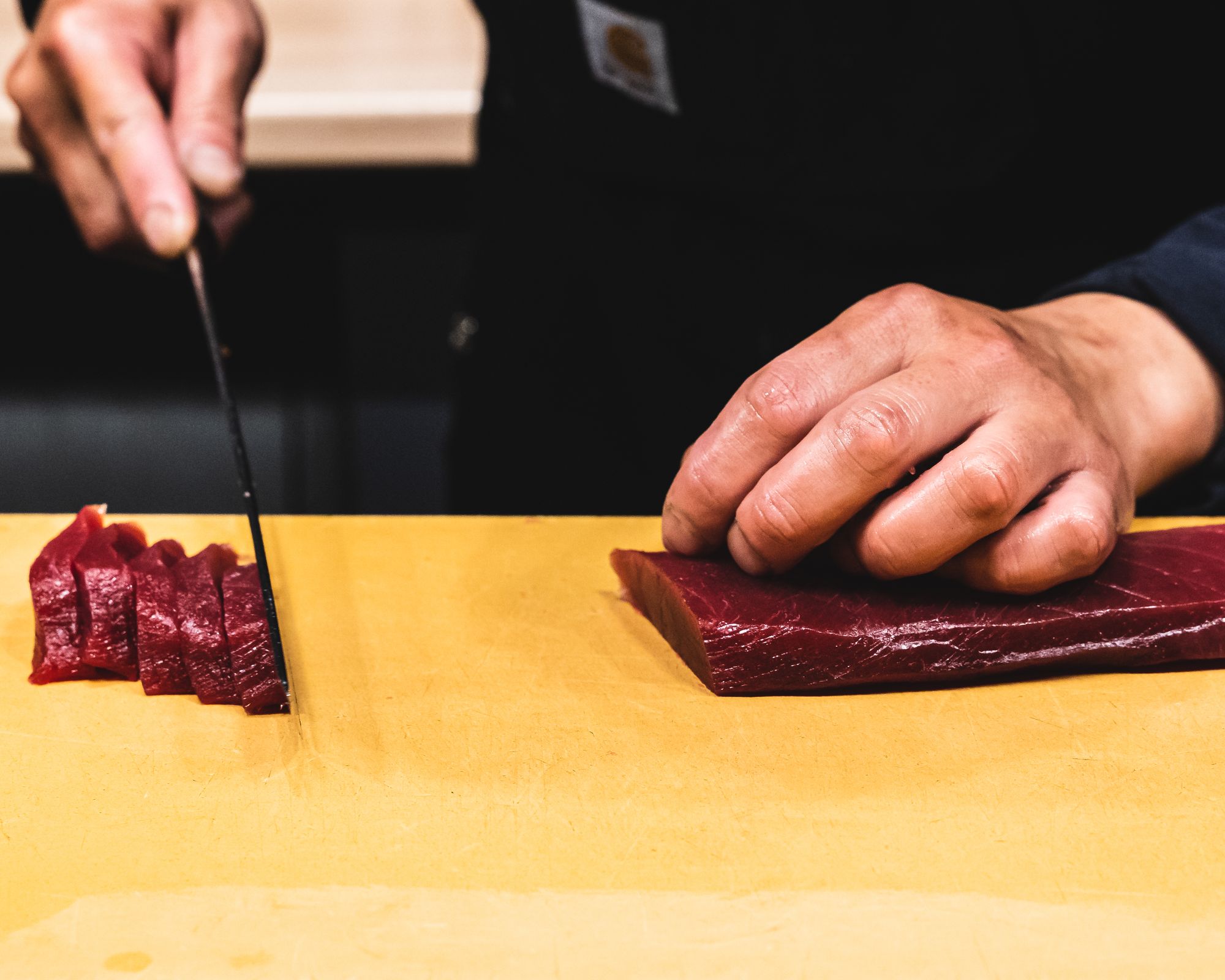 Chef cutting tuna sashimi