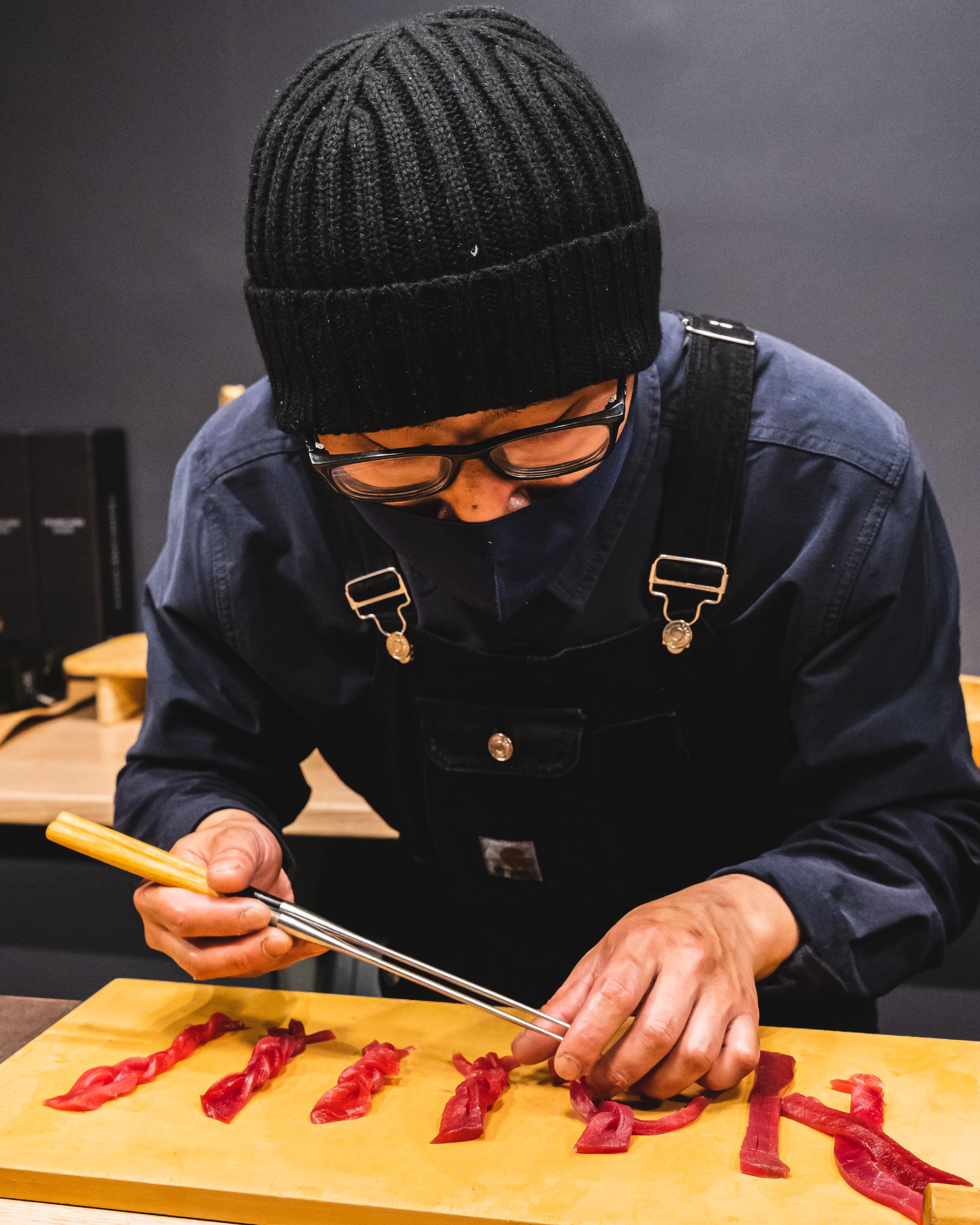 Chef weaving strips of tuna sashimi