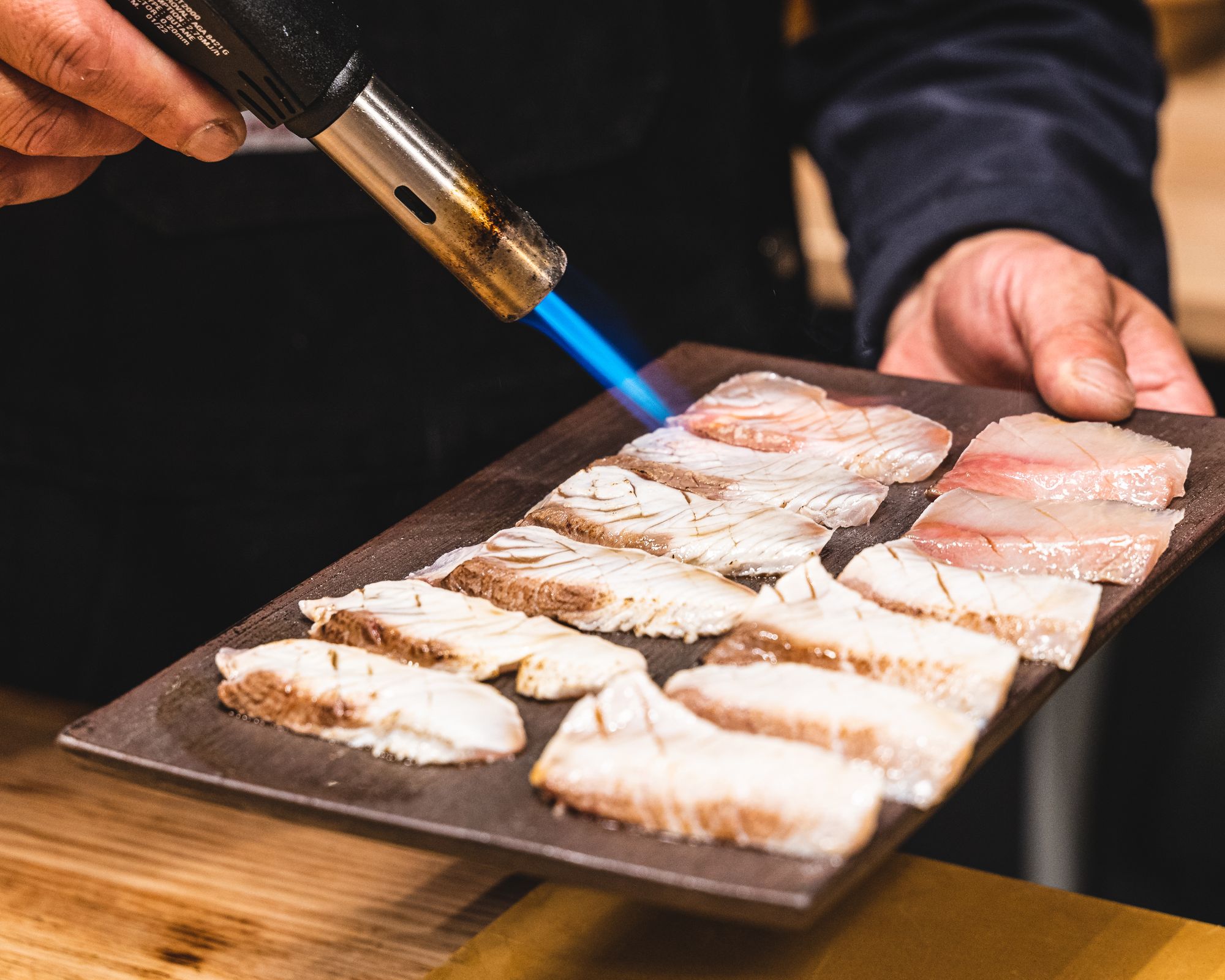 Blow torch searing kingfish sashimi