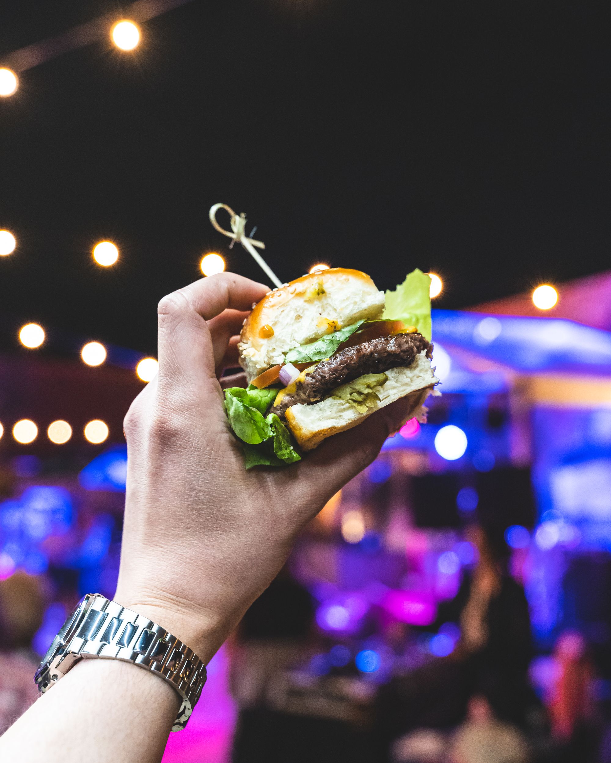 Hand holding a burger slider