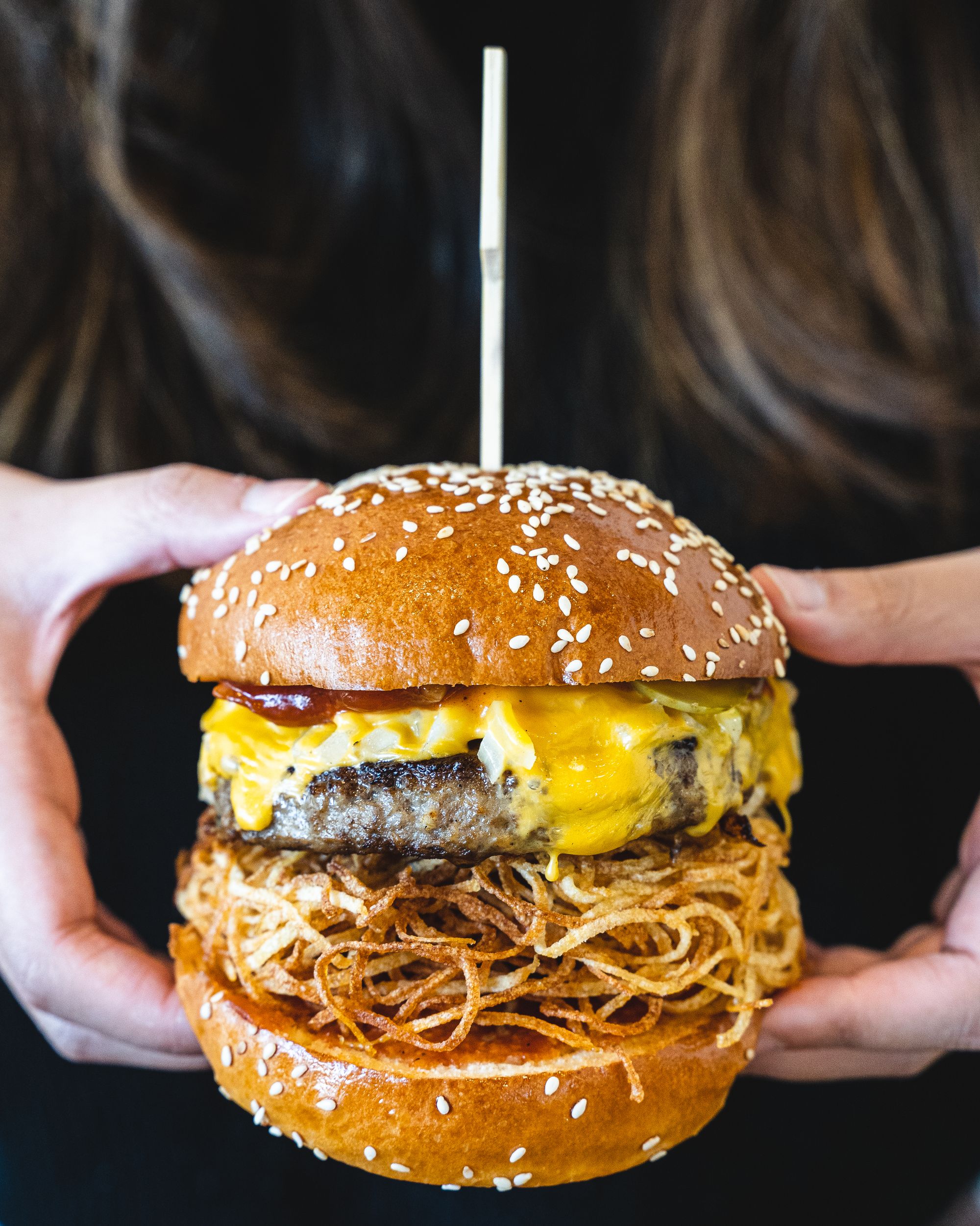 Close of up hands holding a beef burger