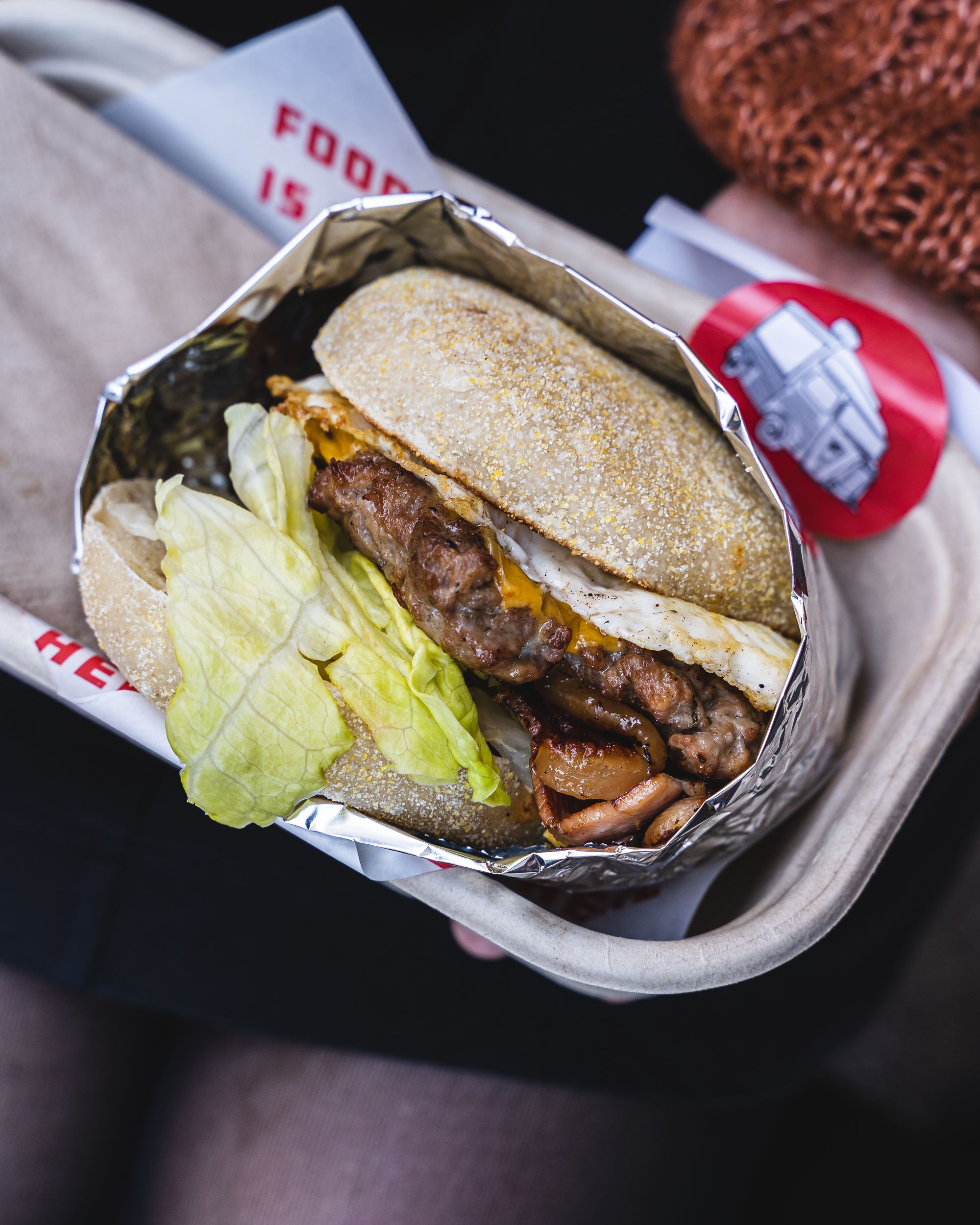 Close up of burger showing the beef patty, egg, letucce and cheese