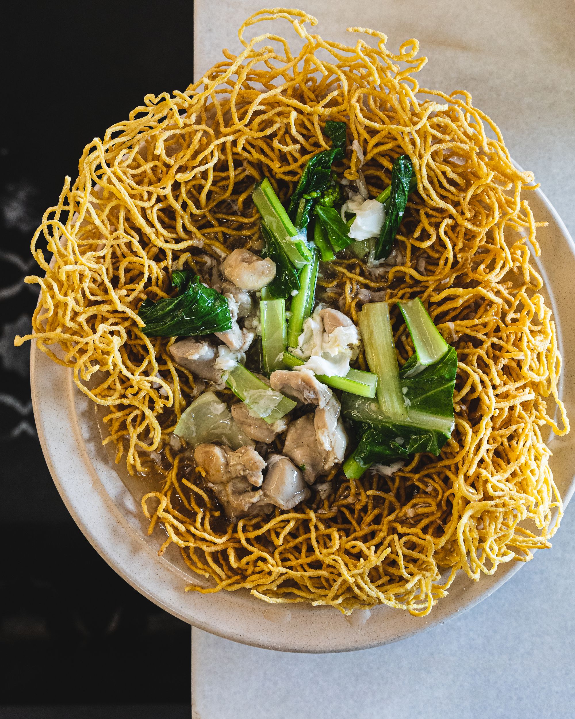 Birds eye shot of chow mein noodles, chicken and vegetables