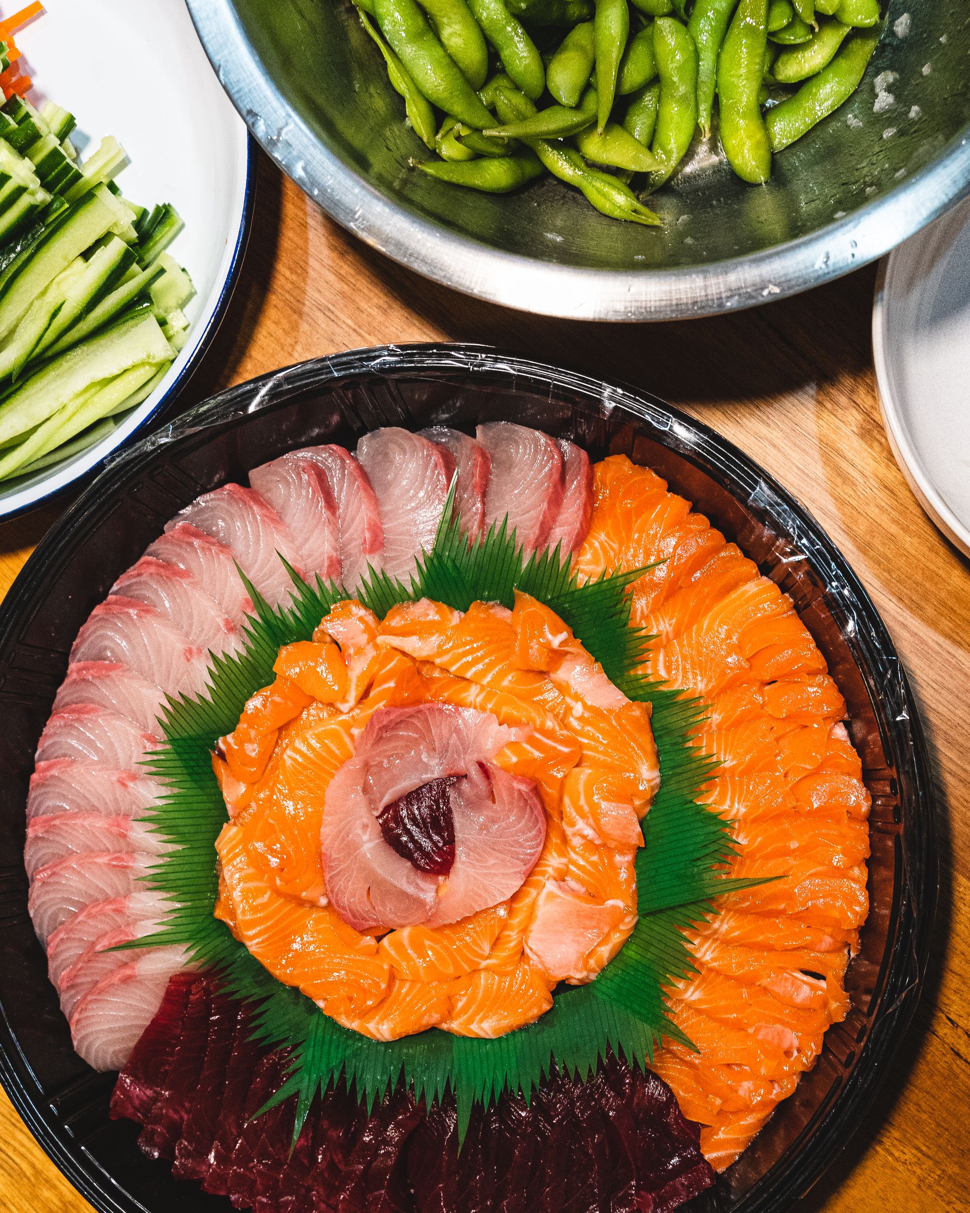 Flat lay of a sashimi platter with salmon, yellowtail and tuna