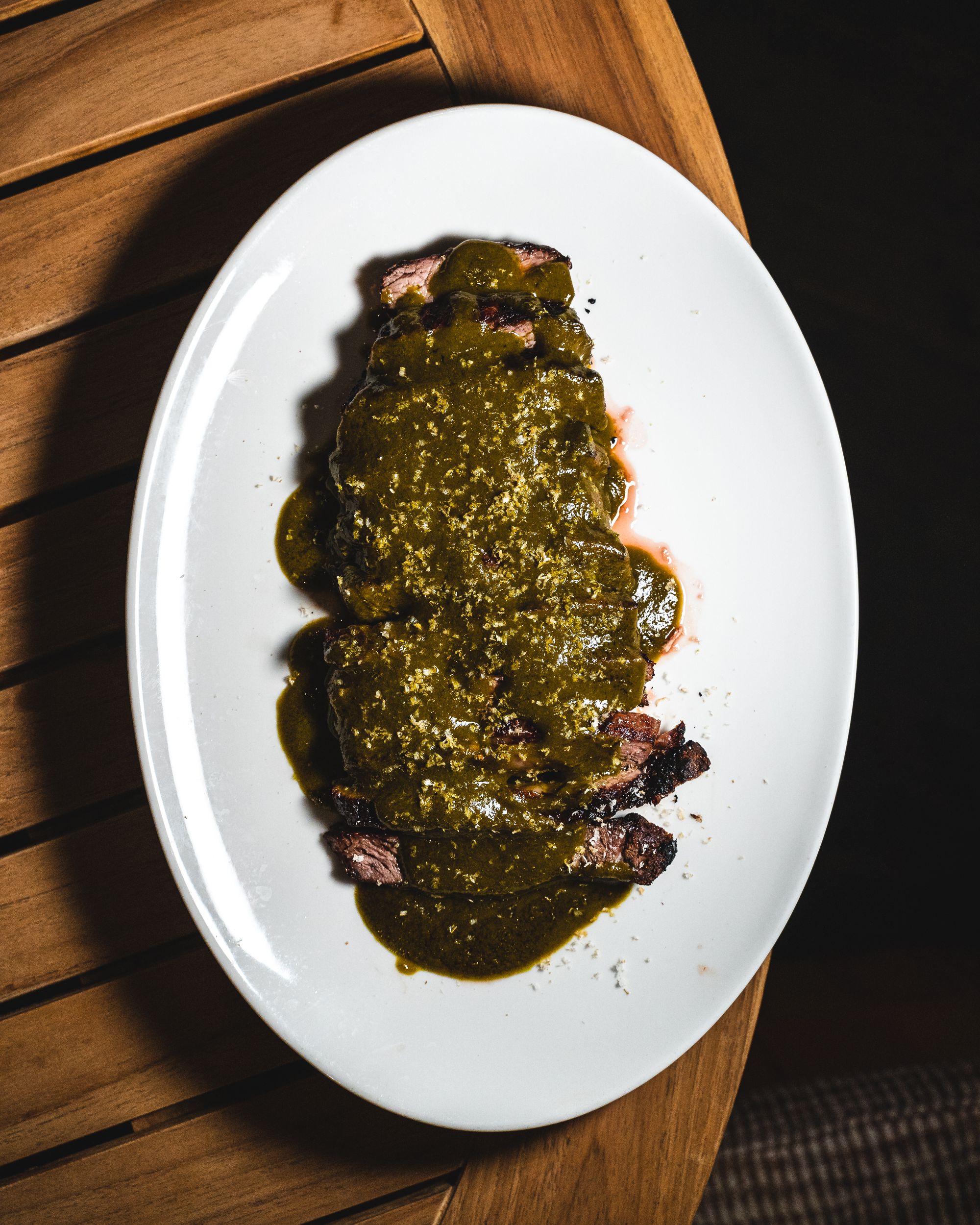 Top down shot of flank steak on a oval plate