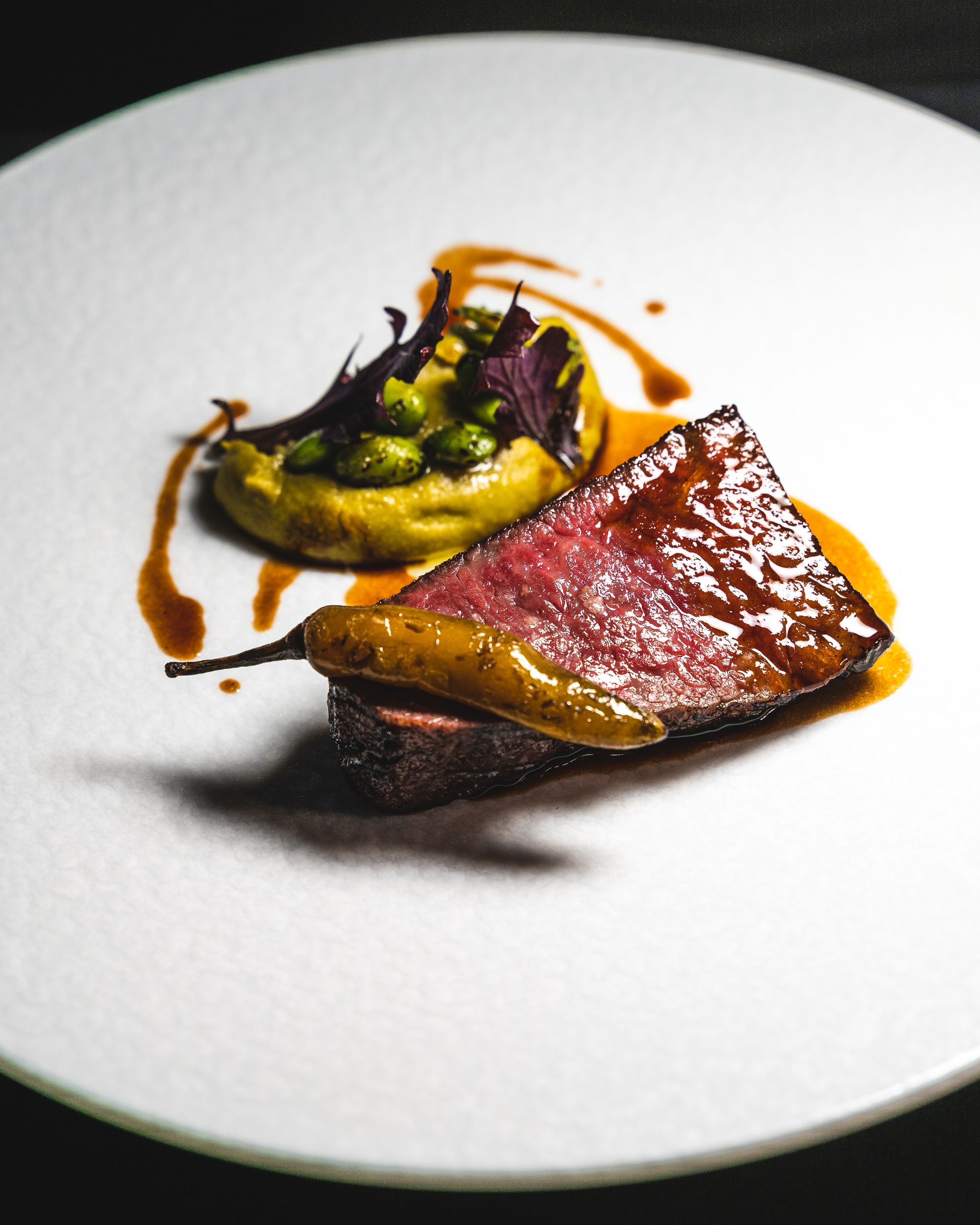 Close up of wagyu with chilli and puree in the back