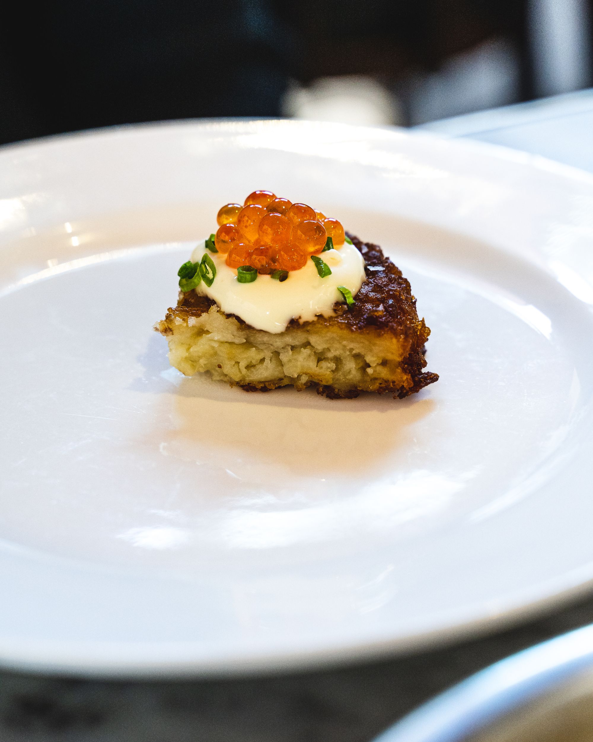 Close up of potato rosti with cultured butter and salmon roe