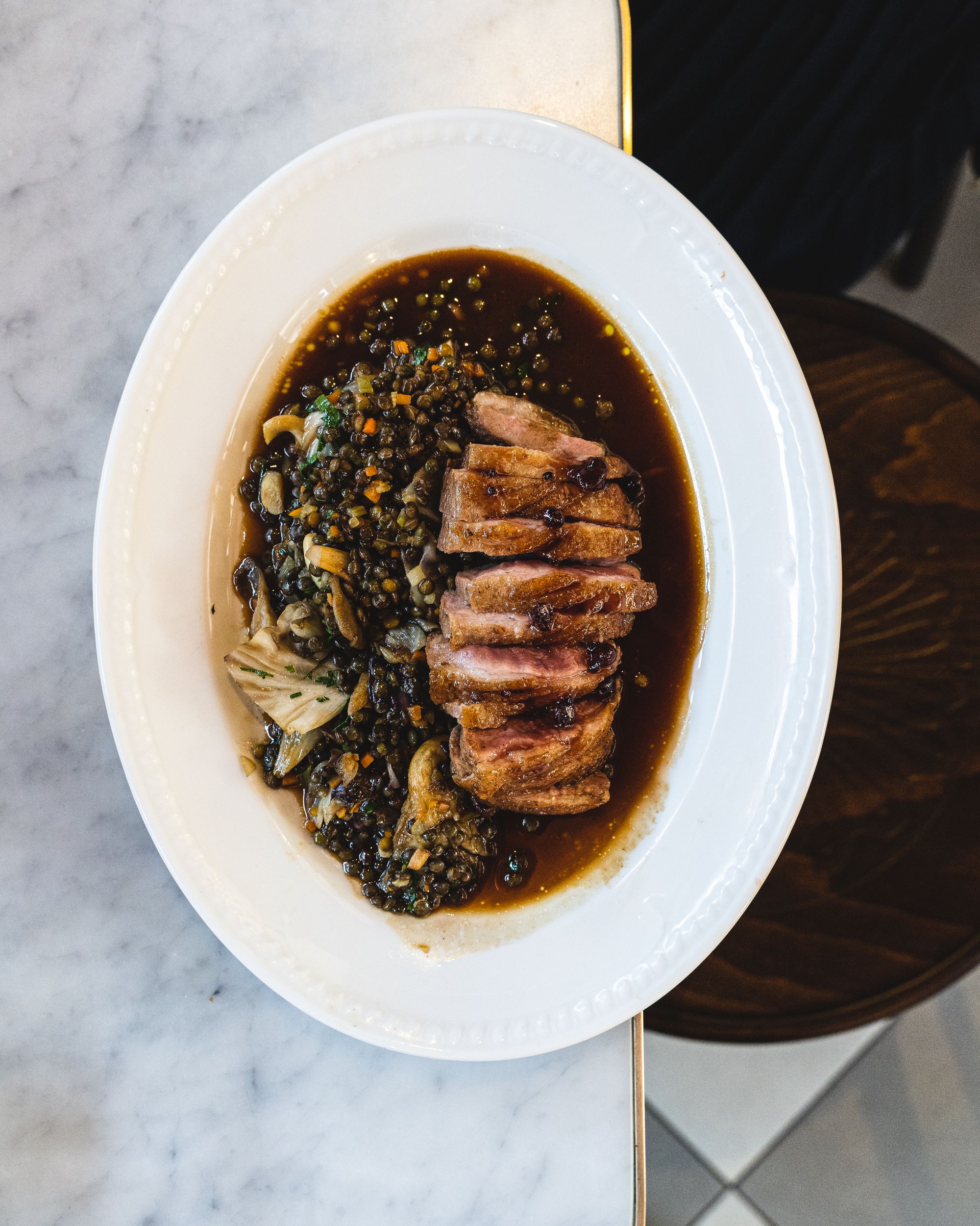 Top down shot of lentils and duck breast