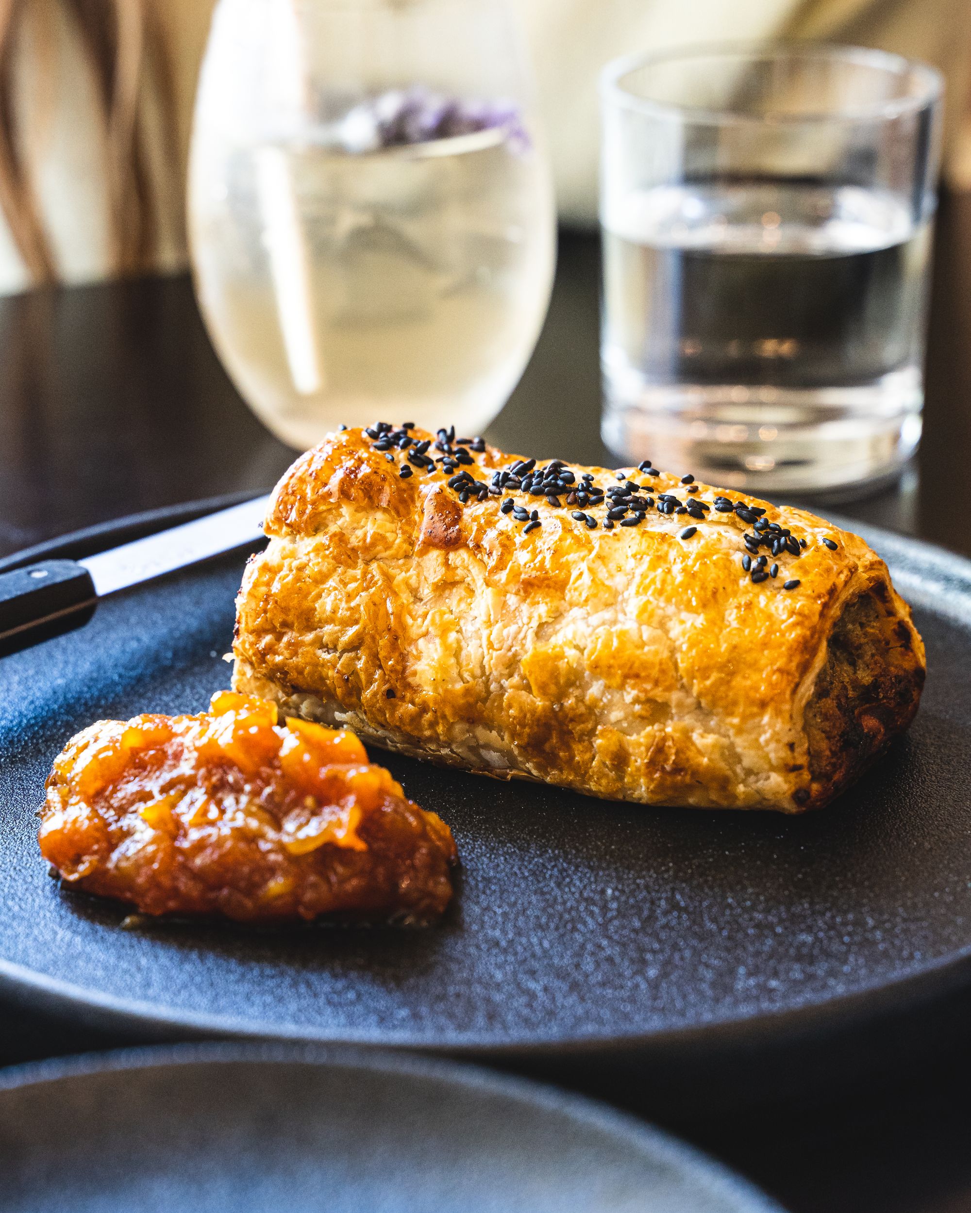 Close up of sausage roll with tomato relish