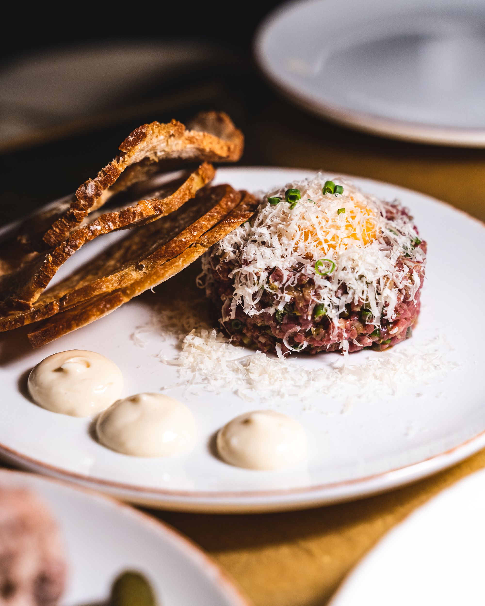 Close up of steak tartare with shaved pecorino cheese