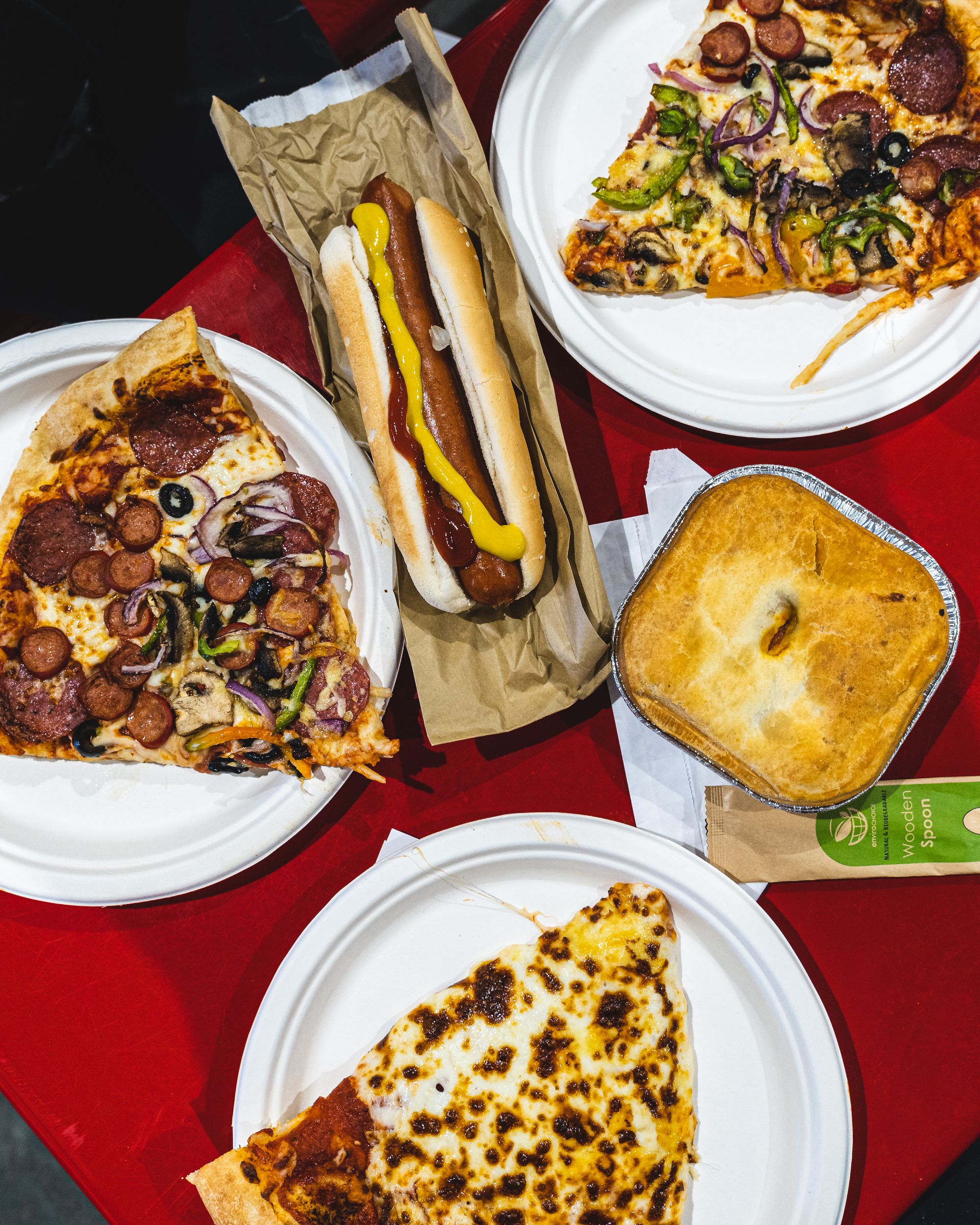 Flat lay of pizza, hot doh and a pie in a silver tray