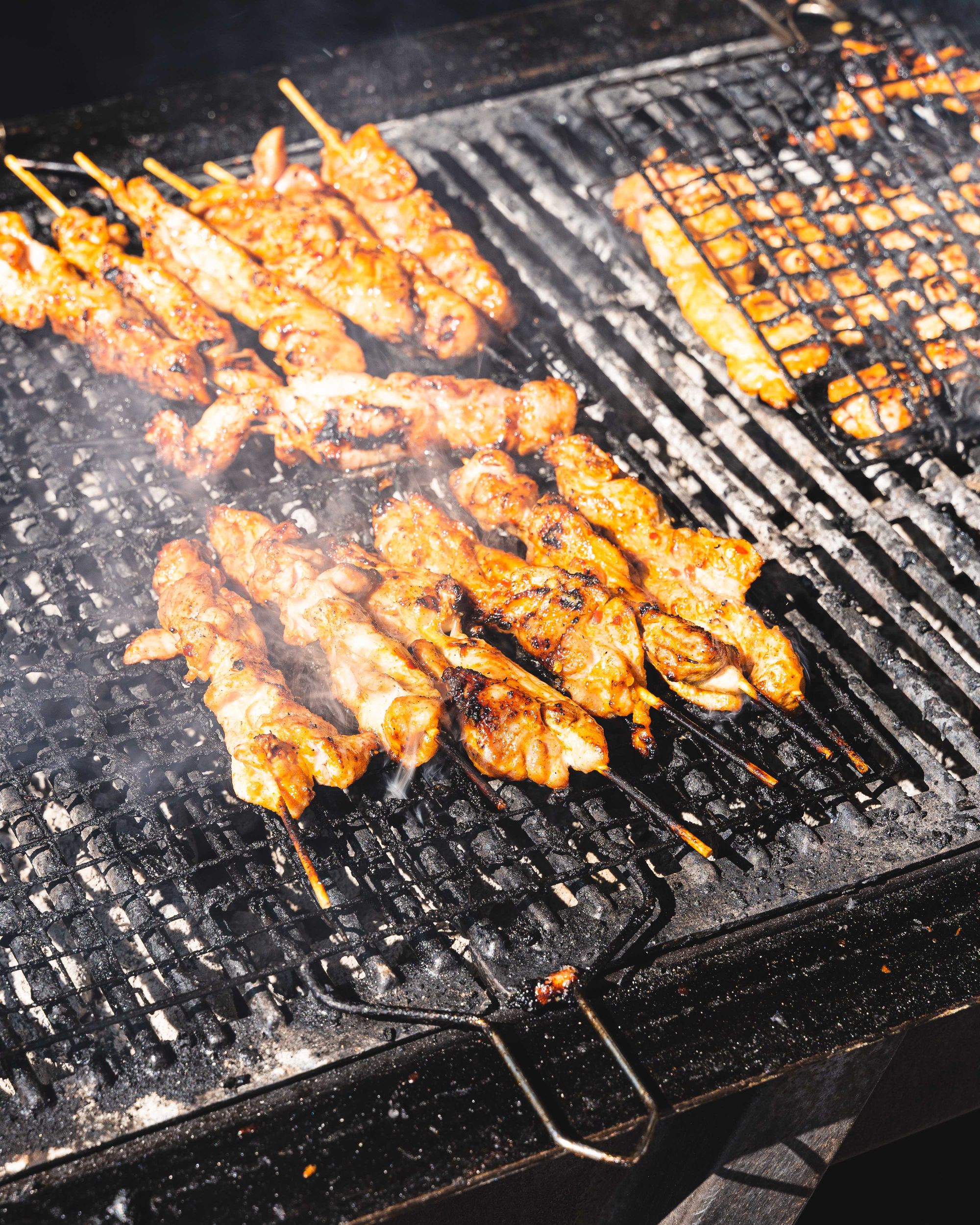 Chicken skewers grilling on a BBQ