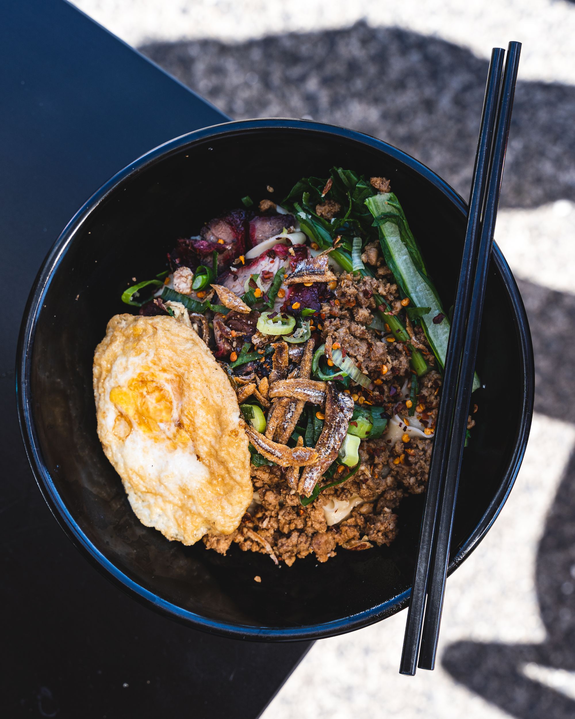 Noodles with fried egg and anchovies