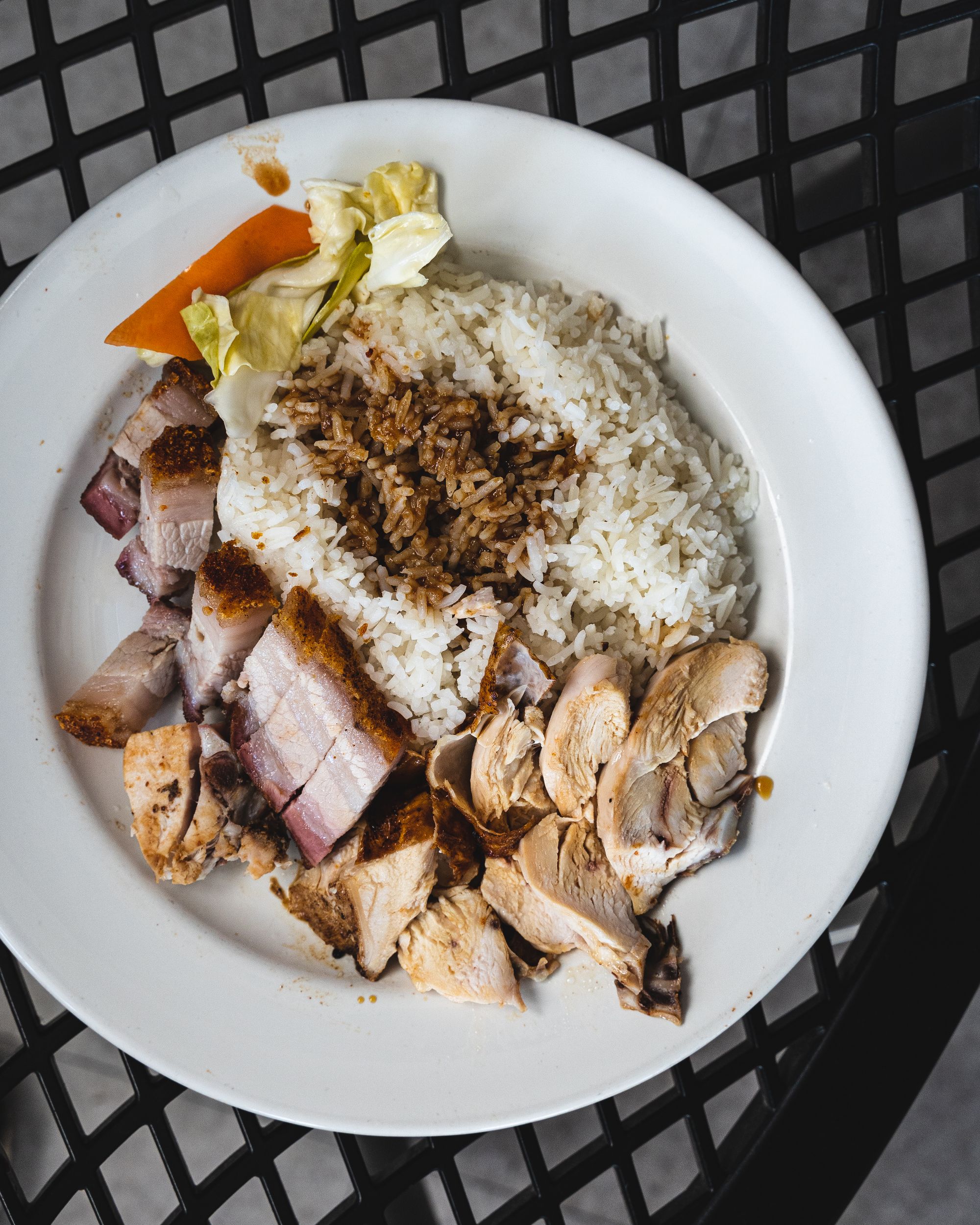 Top down of rice with roast pork and roast chicken