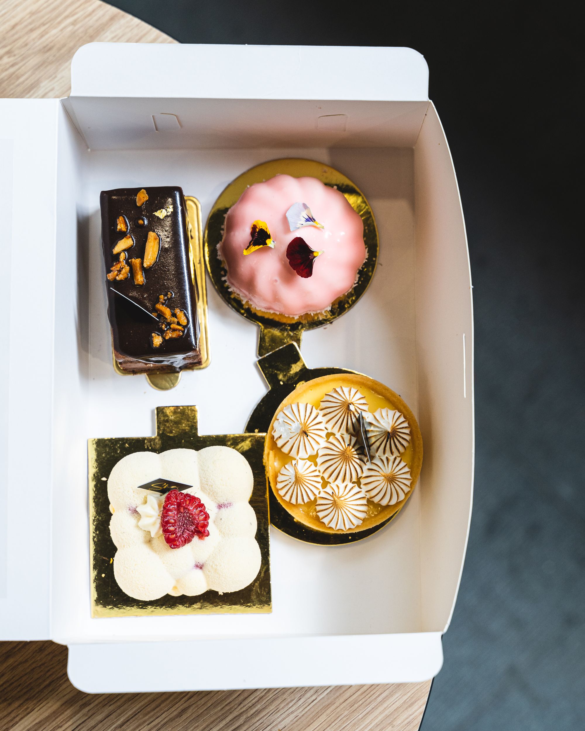 Top down assortment of sweets and cakes in a paper box