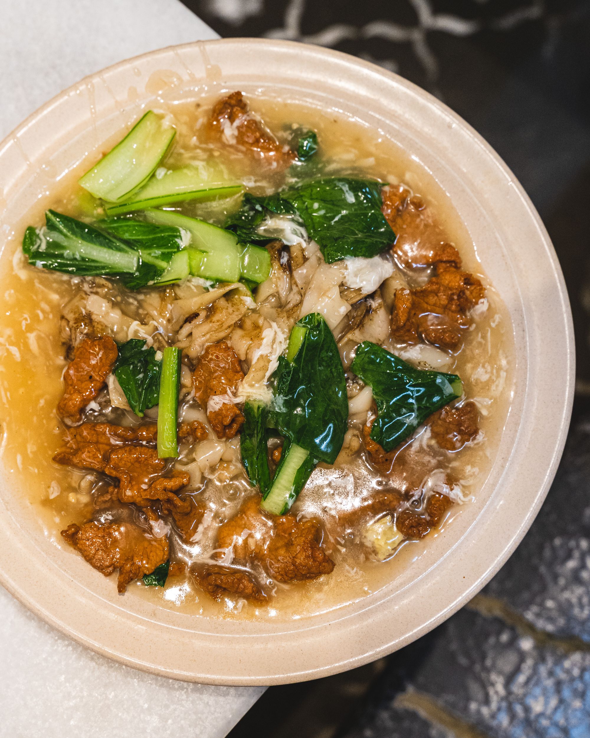Hofun noodles in egg sauce with vegetables and beef