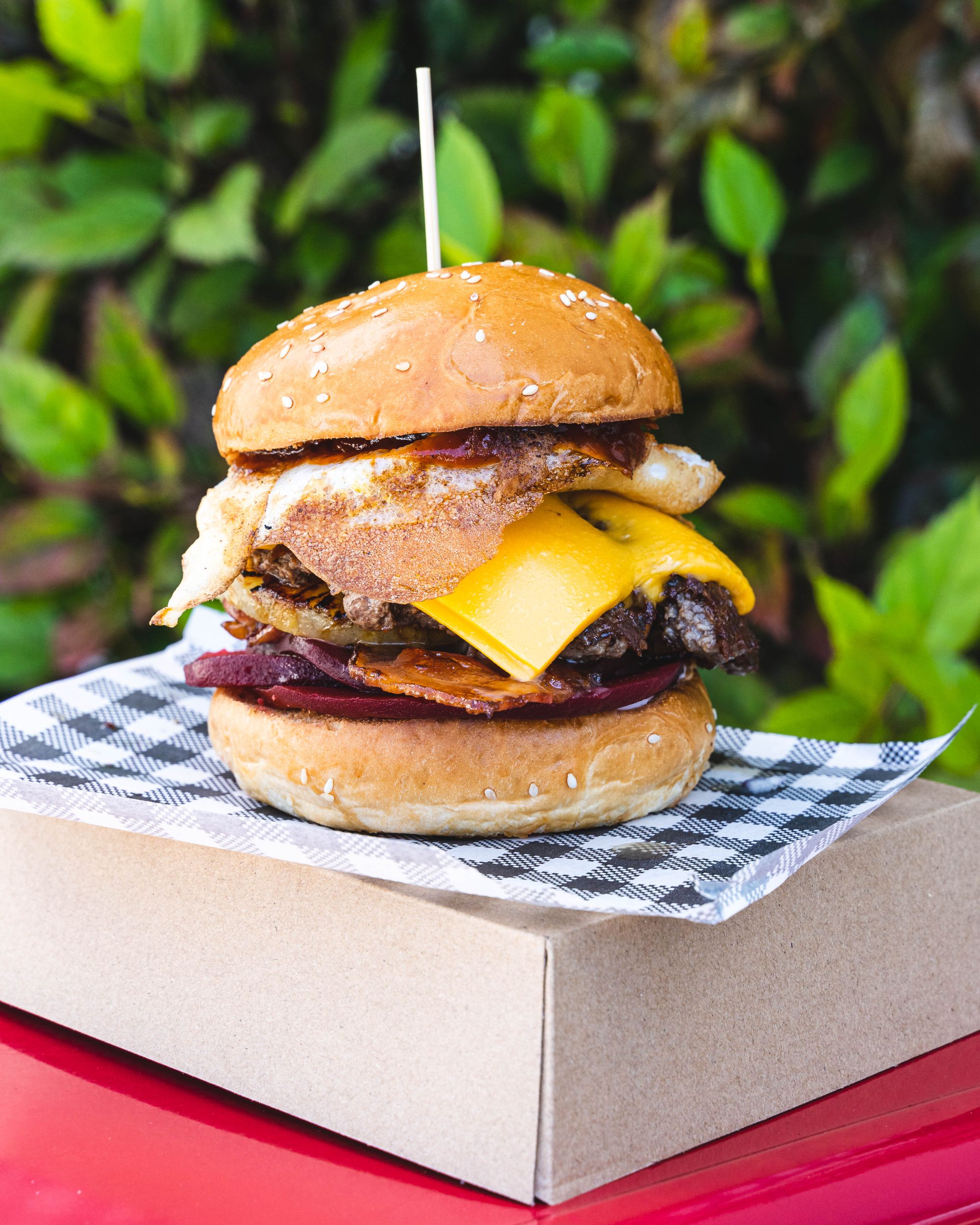 Close up of burger with egg, cheese and beef showing