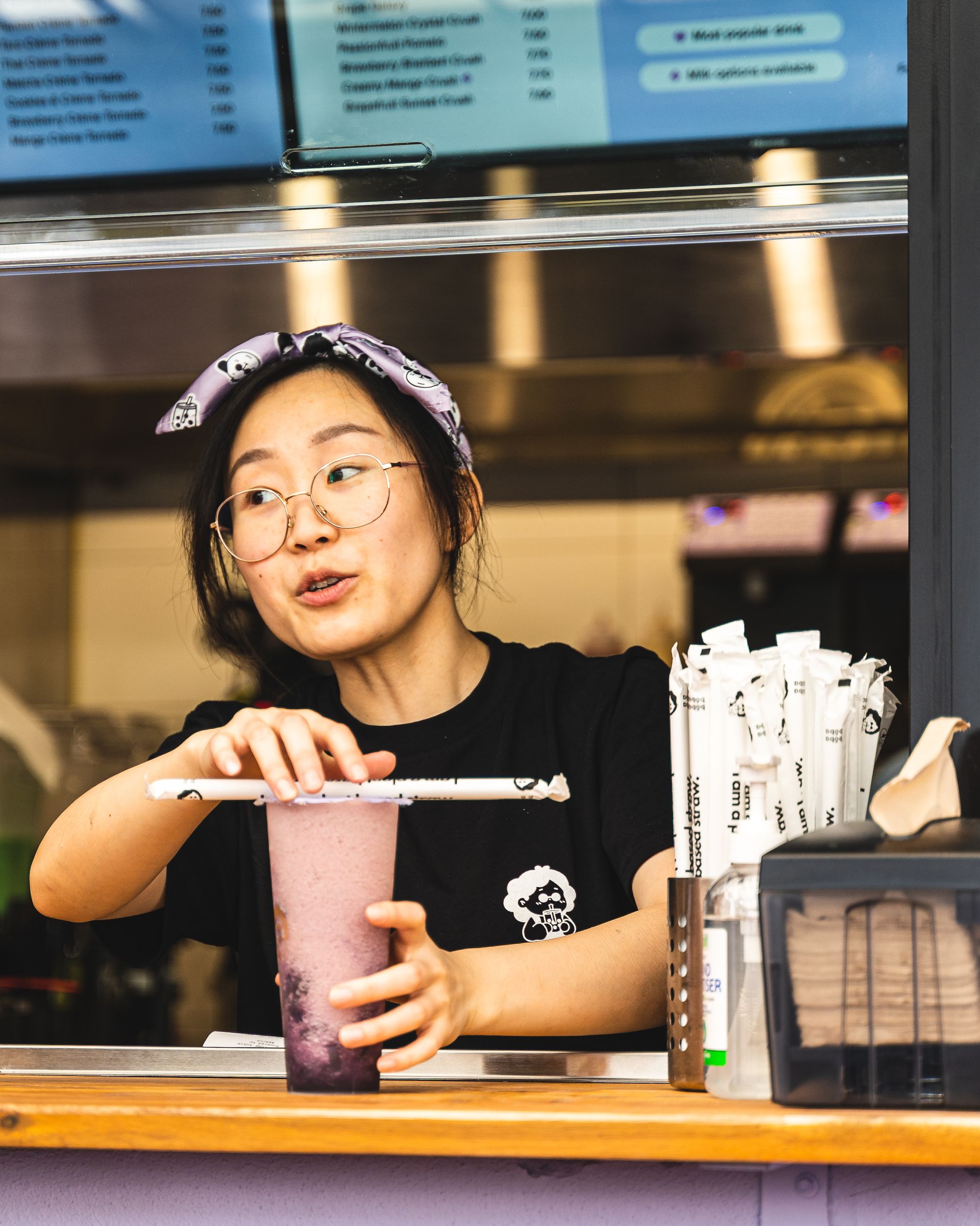 Asian lady placing boba on counter