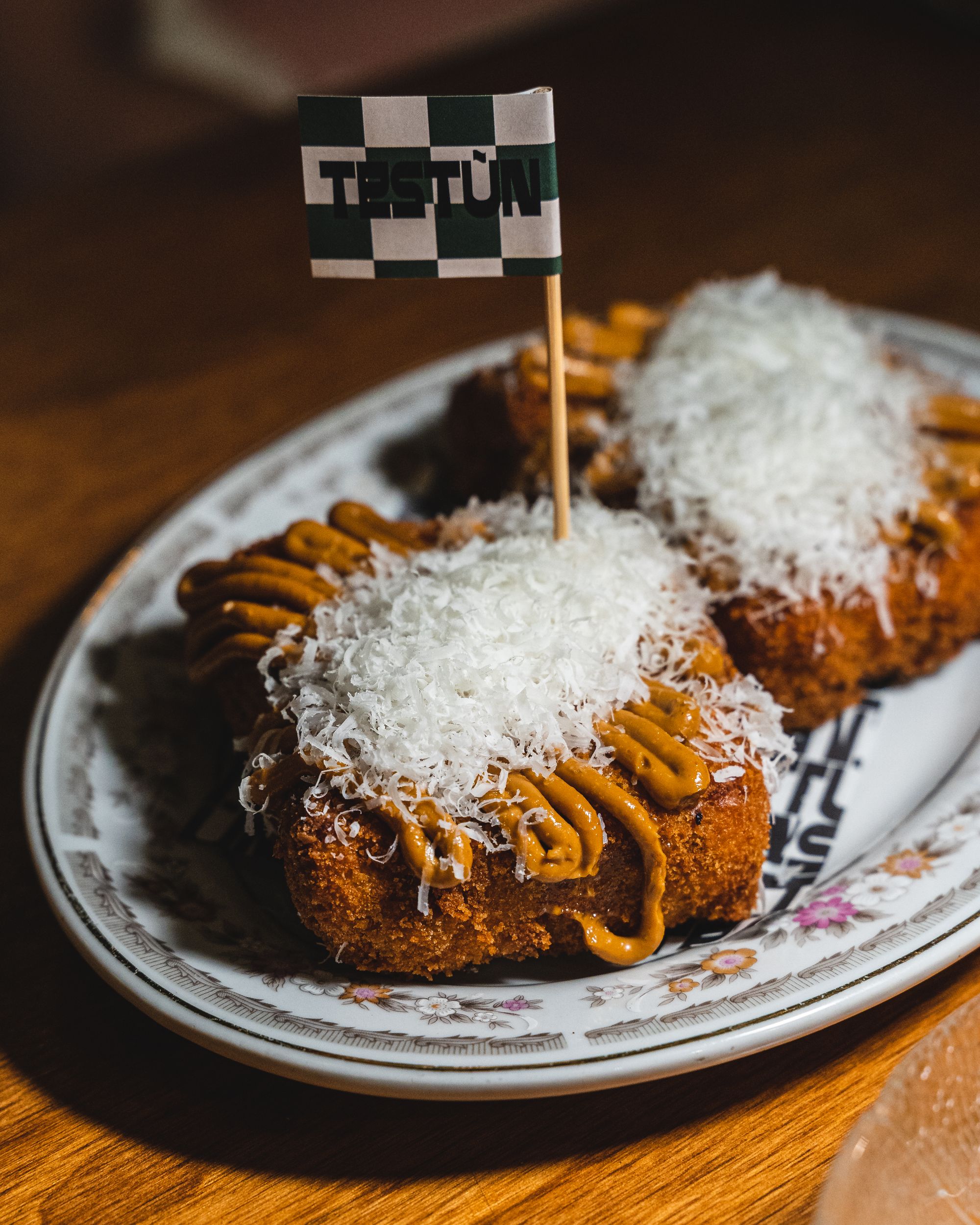 Fried lasagne cubes topped with cheese