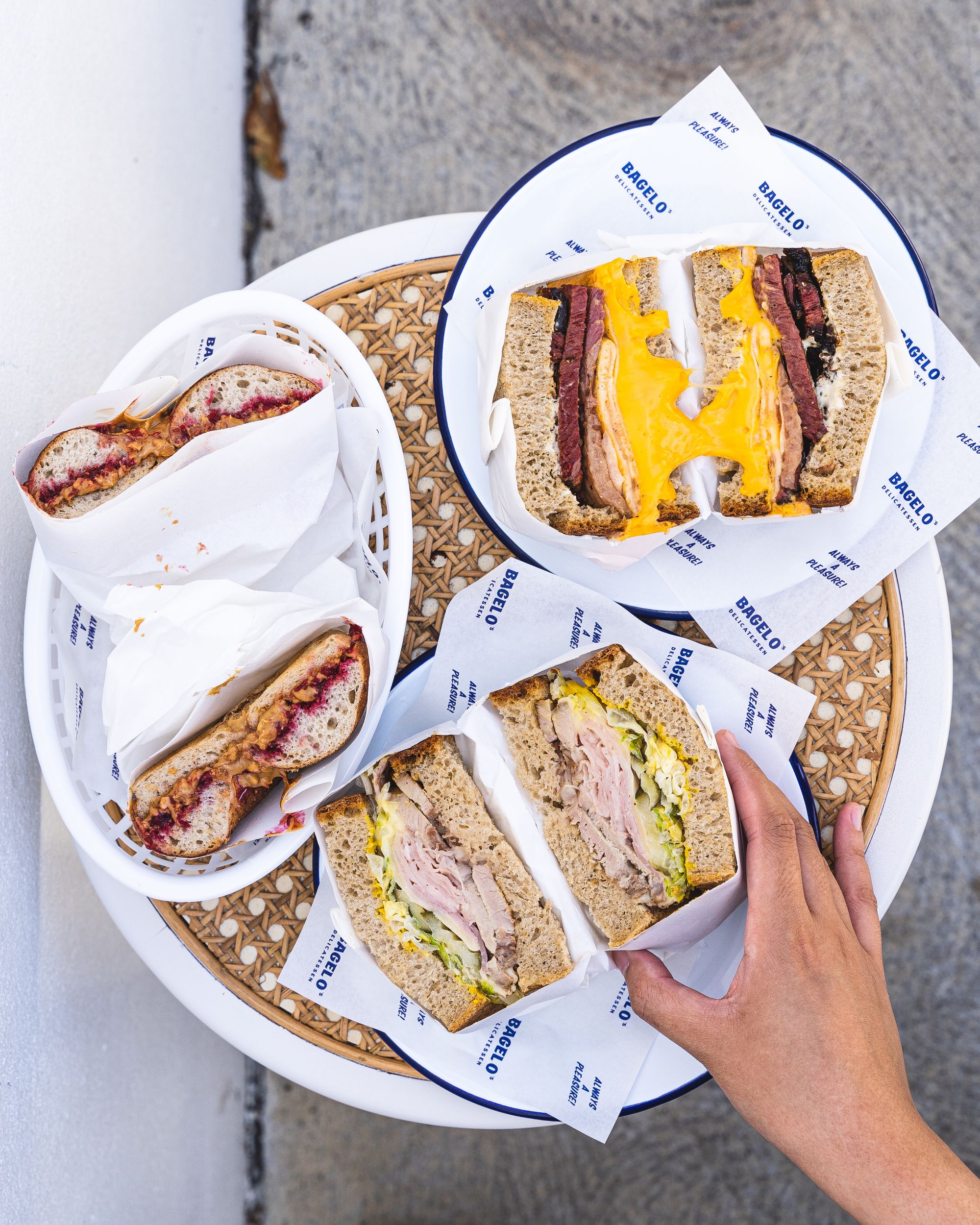 Overhead shot of hand reaching for a sandwich 